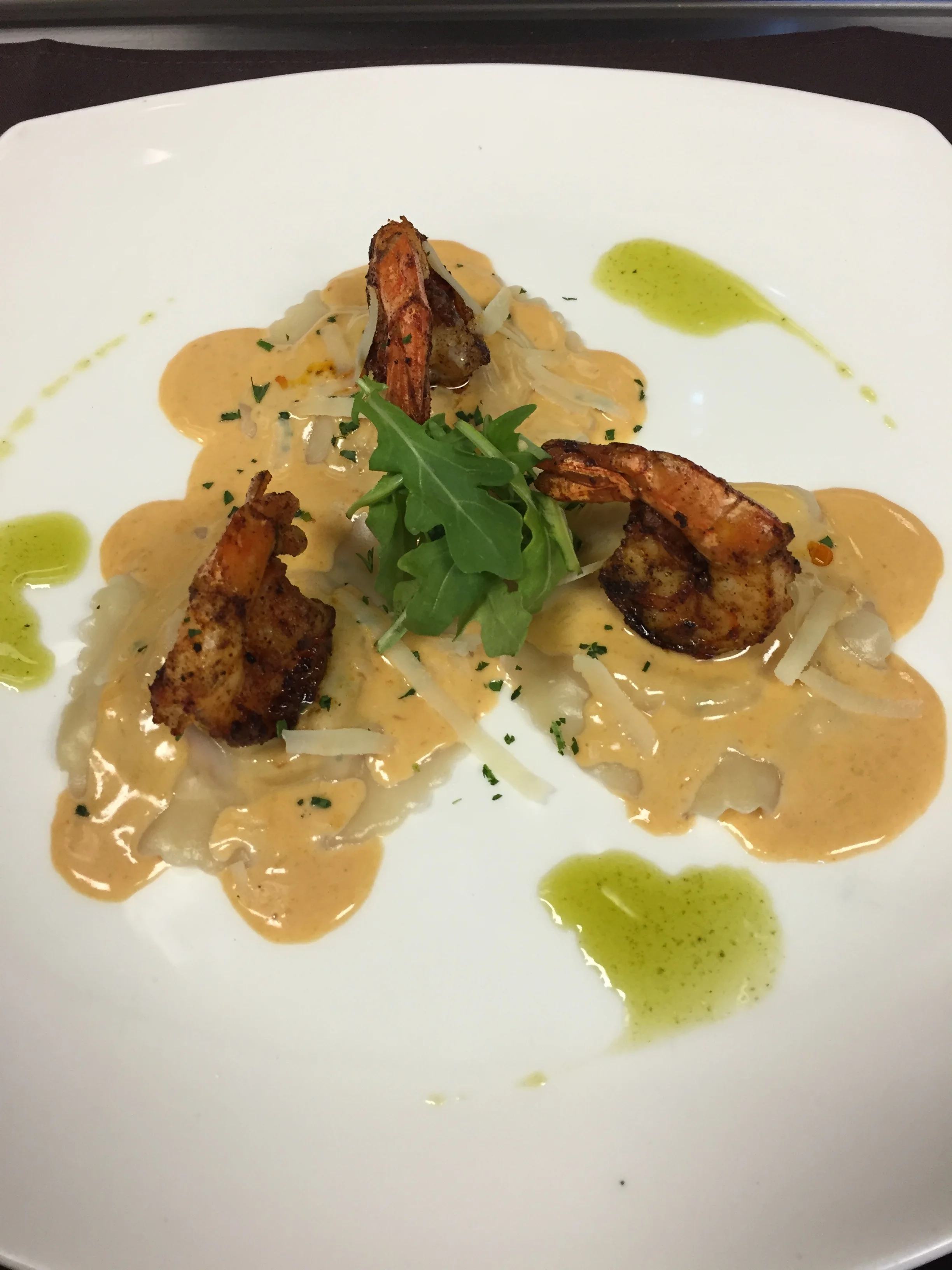 lobster ravioli with cream sauce and blackened shrimp
