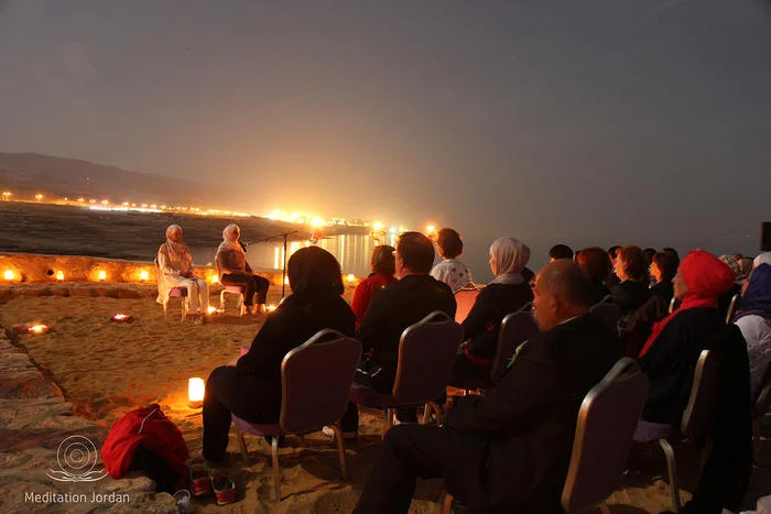 Mediation trainers Nesreen Khashman and Aseel Nassar lead the supermoon mediation beside the Dead Sea.