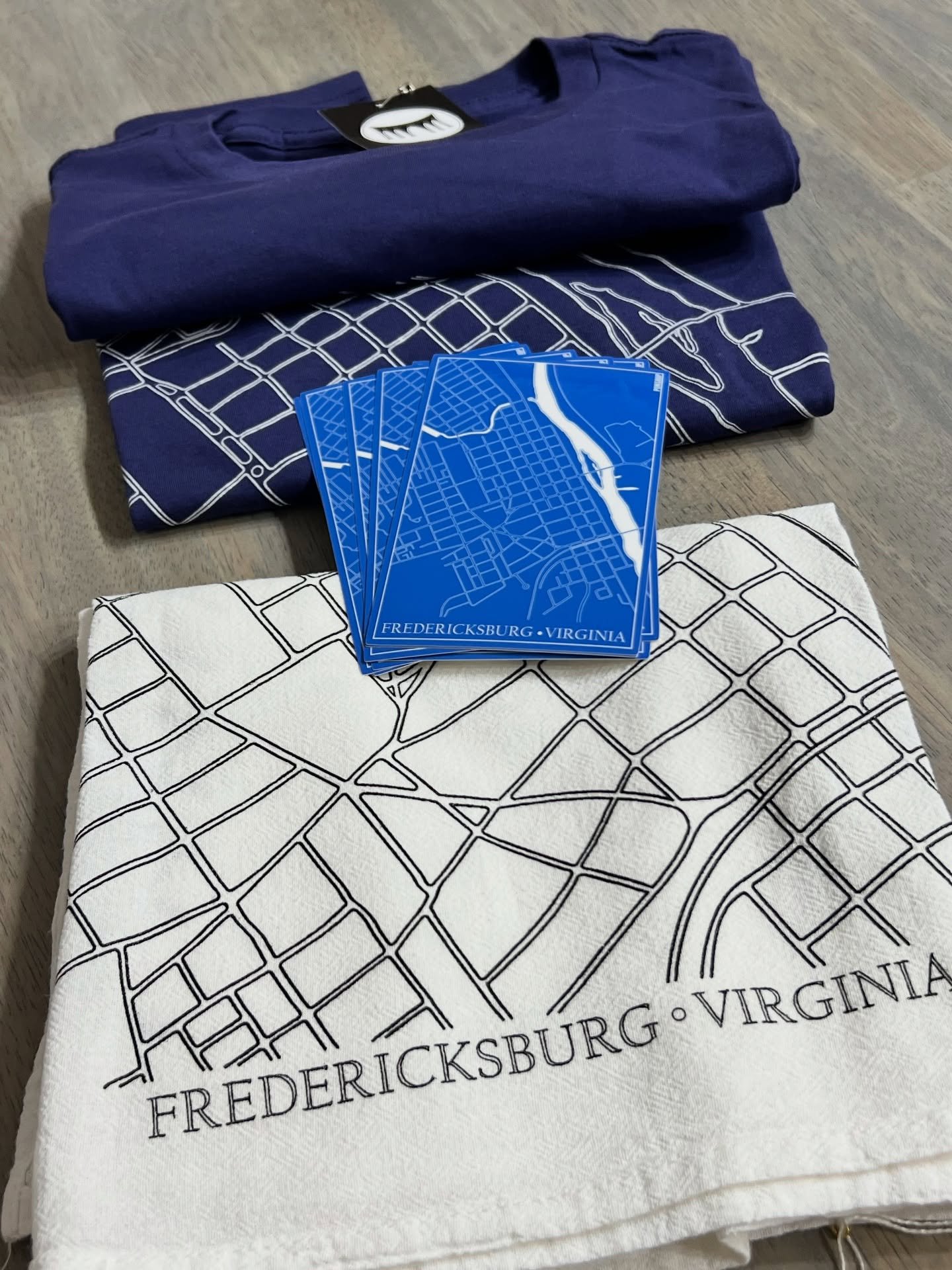 📍Find yourself in Fredericksburg: &ldquo;City Grid&rdquo; tees ($25) Tea Towels ($14) and Stickers ($5) 🎄Open Saturday 12/13 until 8pm. #fredarts #lovefxbg #fredericksburgva #ponshop #❤️fxbg