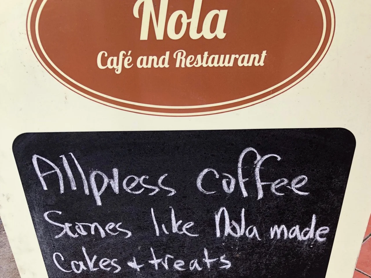 Nola cafe sign