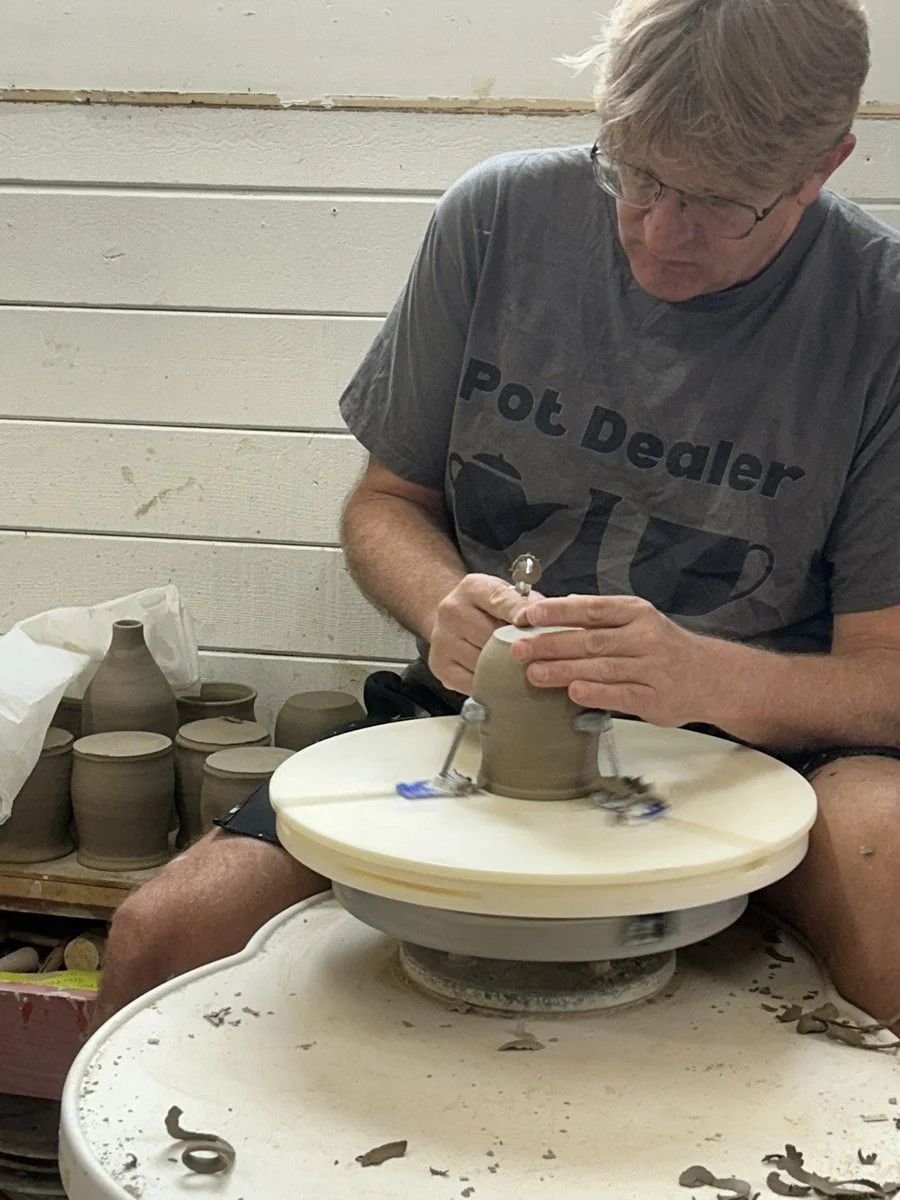 the pottery dealer is trimming.jpg