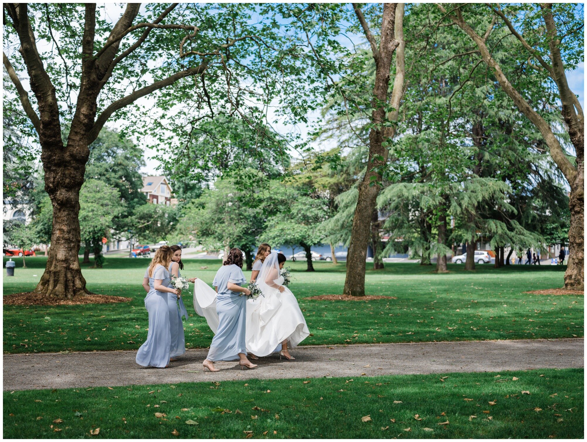 bride and bridesmaids walking at green lake in seattle.jpg