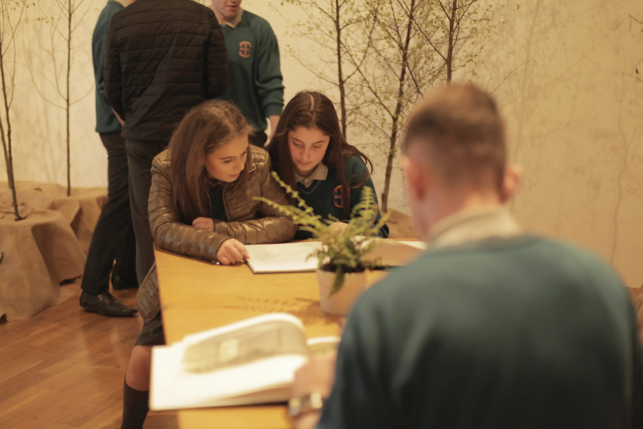 Students looking at artwork created by artist Jane Locke detailing research on the history of the postal system; at Futures exhibition 2017 at RHA Gallery, Dublin