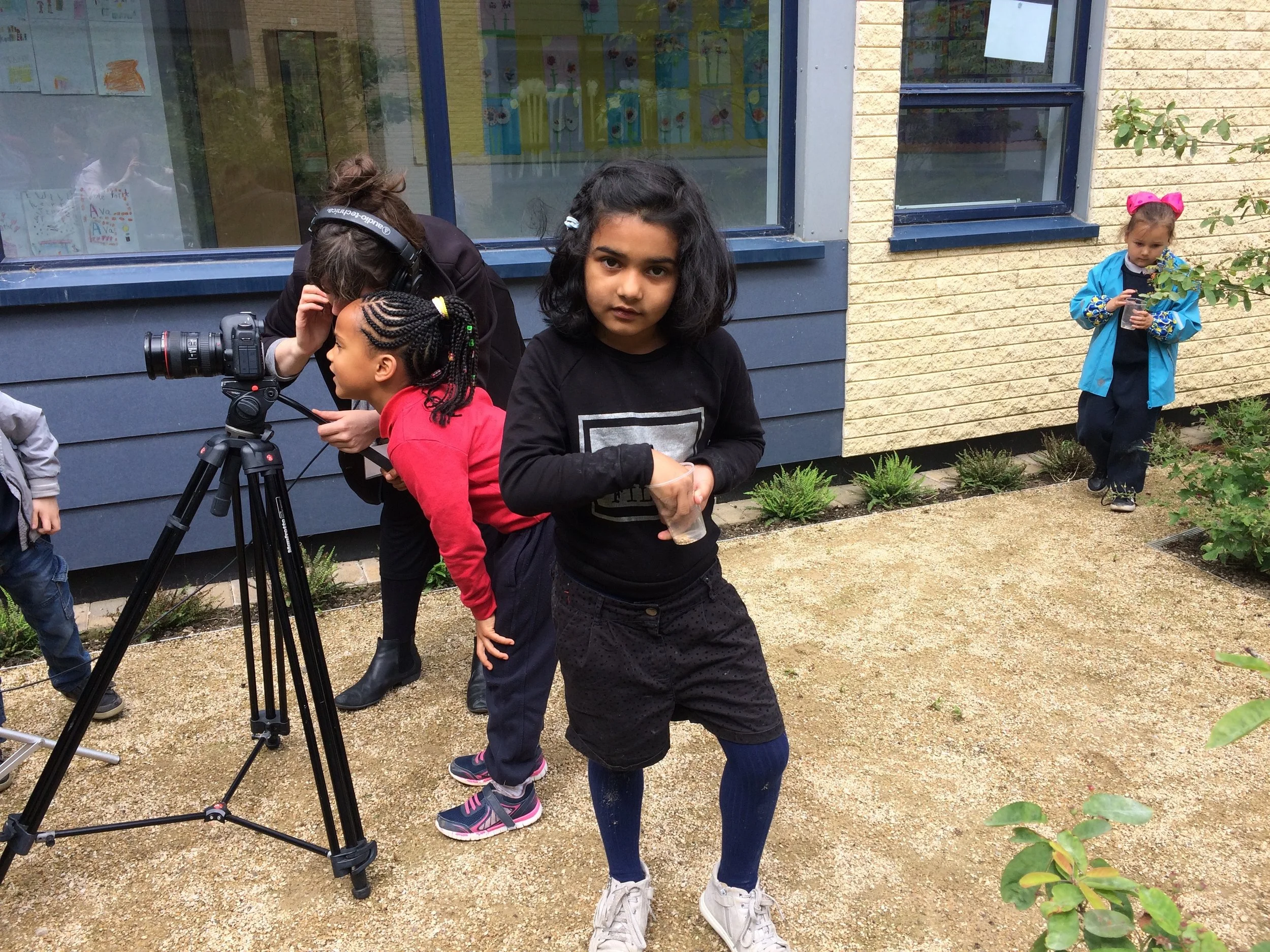 Children were given cups of seeds to create drawings