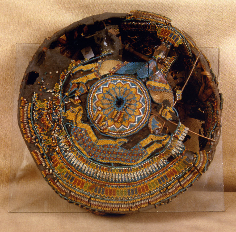 Above - one of the beaded hassocks found in the tomb of King Tutankhamun, yielding the earliest known renderings of the human figure in beads, ca. 1332-1323 BCE. A common motif in King Tut's day, the figures represent the African and Asiatic enemies of Egypt - one of the earliest surviving examples in beadwork of thematic content, in this case, of a sociopolitical nature. The technique looks to be one- and two-drop peyote stitch. The hassock is preserved at the Egyptian Museum in Cairo. Image courtesy Egyptian Museum, Cairo.
