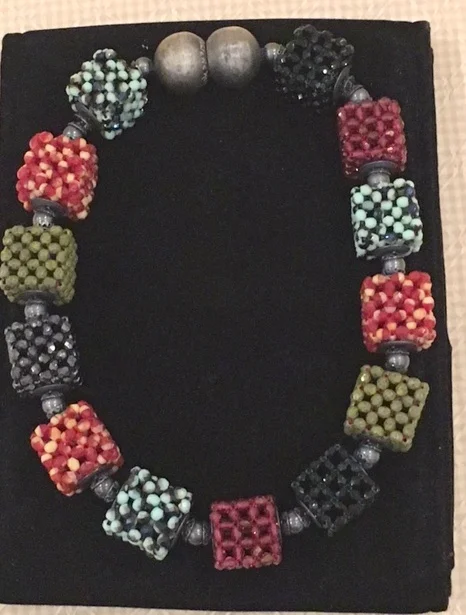 A Multicolor Three-by-Three Cube Necklace, acquired at the Palm Beach Fine Craft Show in February, 2016 by Myrna L., of the Palm Beach, FL area. Myrna says: "I have worn this necklace so many times and get many wonderful comments. I was in a store in Palm Beach with my niece, and a stranger offered to buy it."