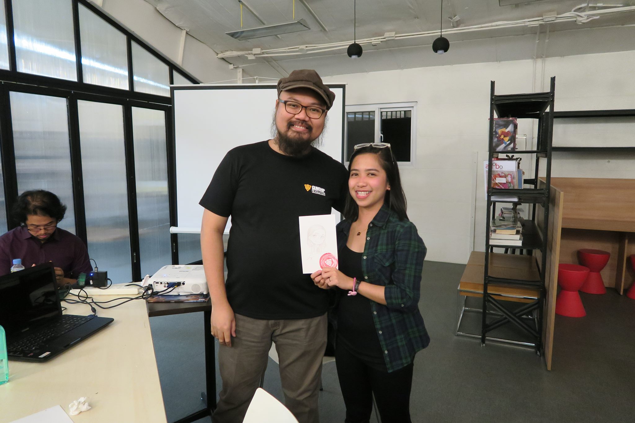 Senior Art Director Kriss Sison leaves guest Michelle Ladia home with a souvenir sketch.