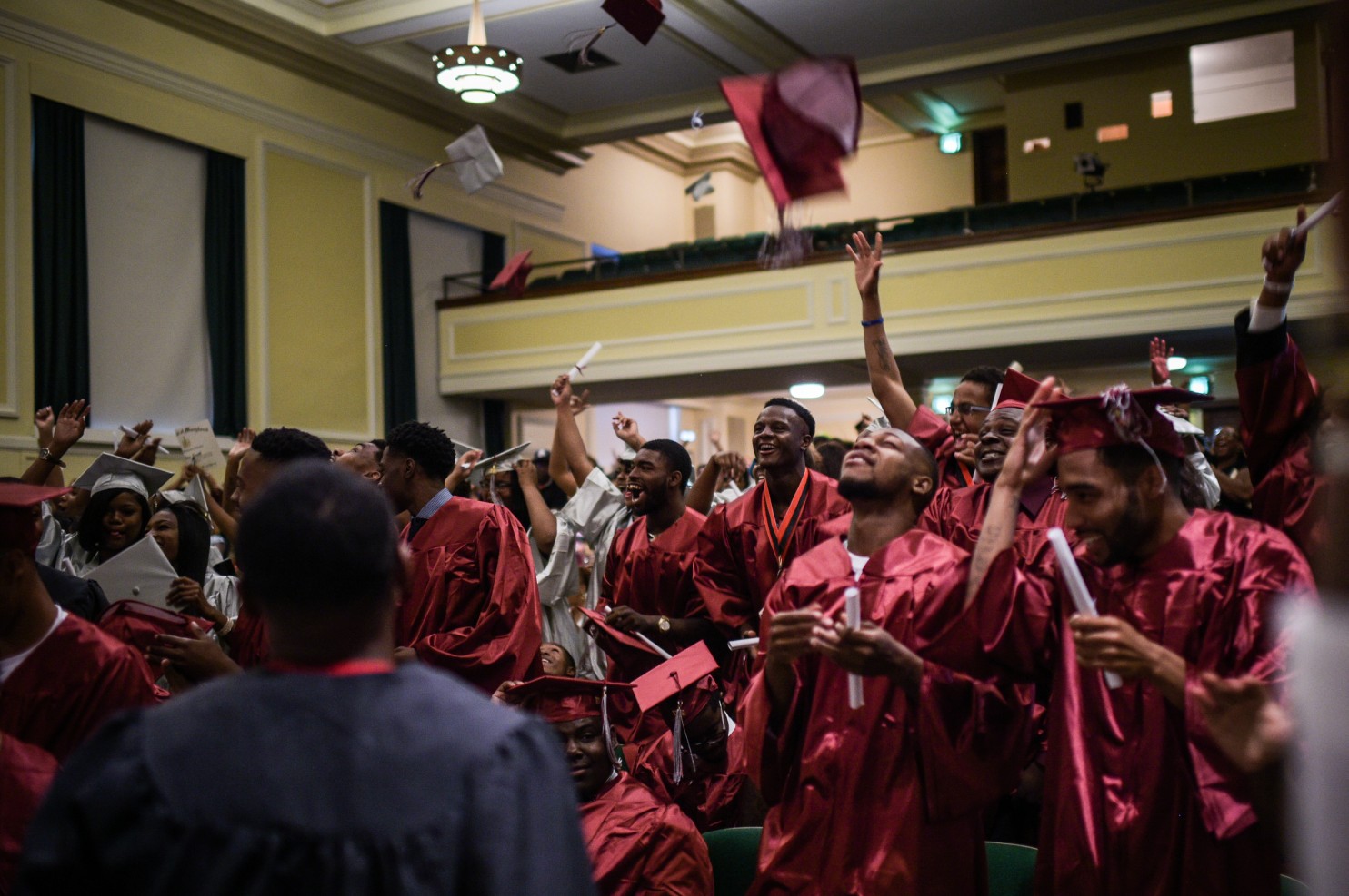 Excel Academy seniors throw their caps in the air after the graduation ceremony. (Salwan Georges/The Washington Post)