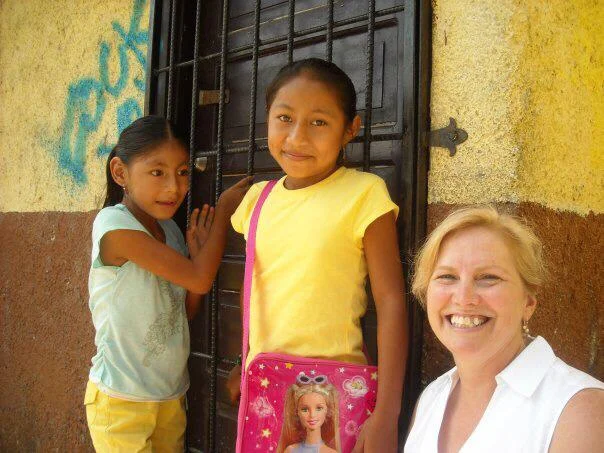Elevat Co-founder Julie Johnson with sponsored child and her sister