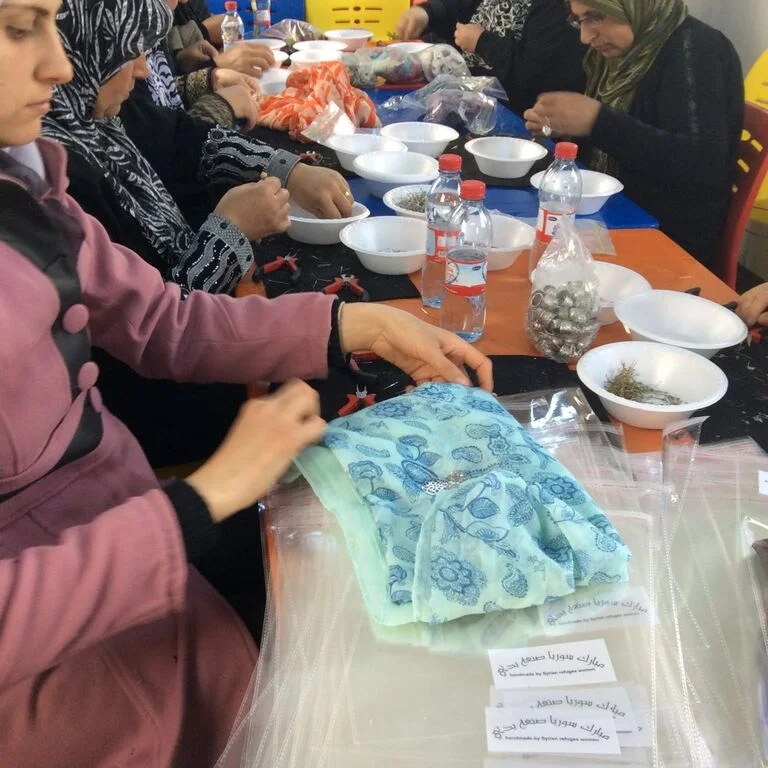 Syrians make scarves at a refugee camp in Jordan