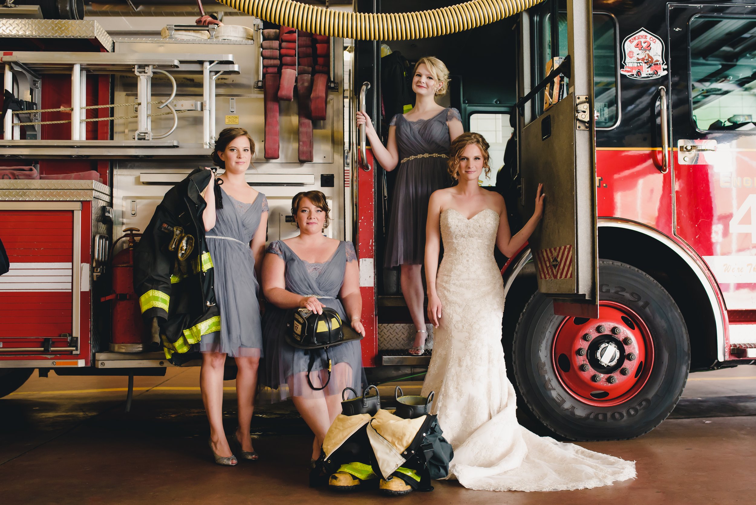  Bride and her bridesmaids by a firetruck  
