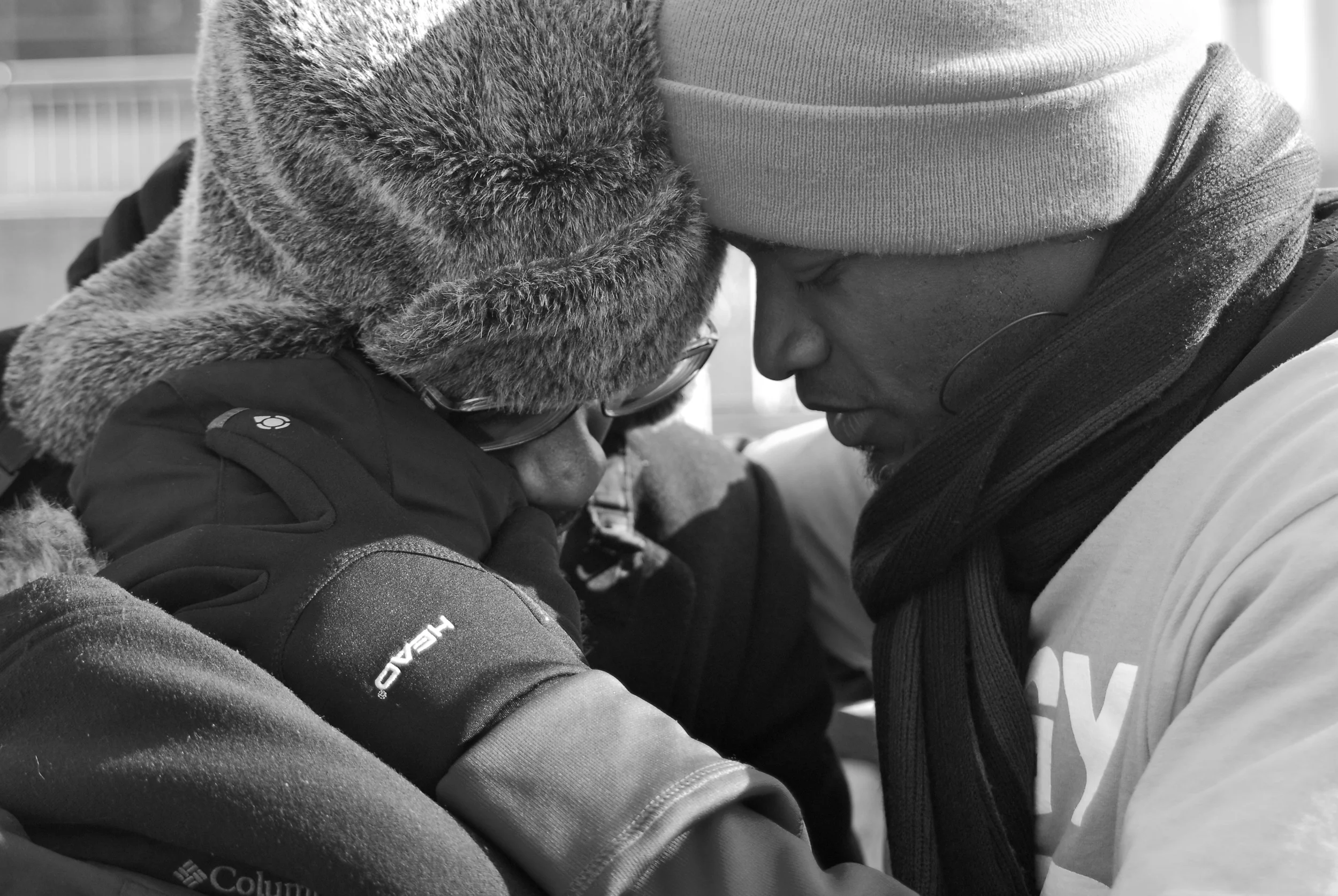  The woman who was being held had just finished making an emotionally driven speech to the crowd gathered to protest. After she was done, she broken down in tears and I later found out (when I tried to get their names) that these two men didn't know 