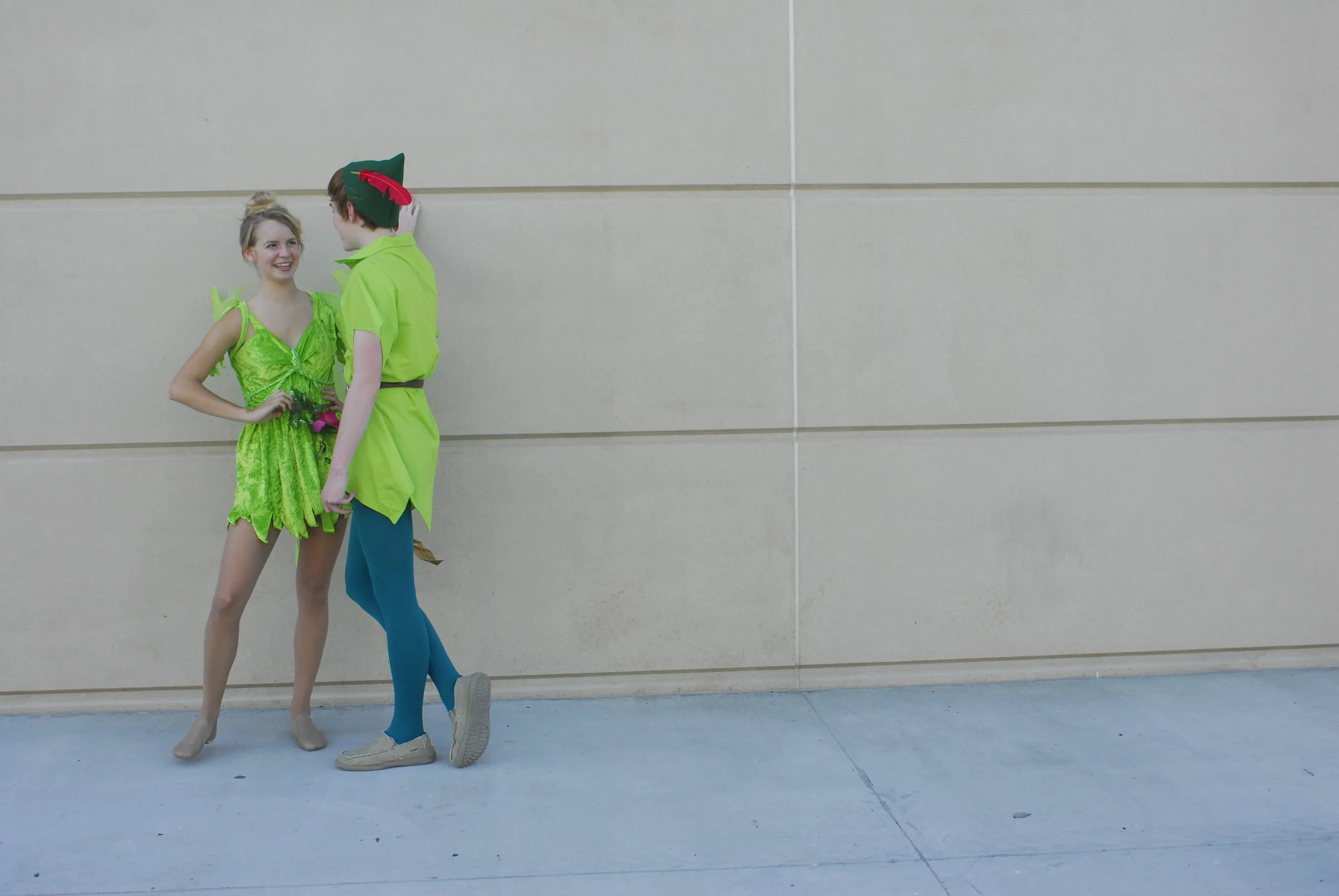  Leslie Wagner, 15, dressed as Tinkerbell and Neil Cathro, 16, as Peter Pan, take a break from greeting guests to the Poster Party of the Arts held at the East Tower Columns Lounge at Memorial Stadium on Thursday. Both Wagner and Cathro are in a thea