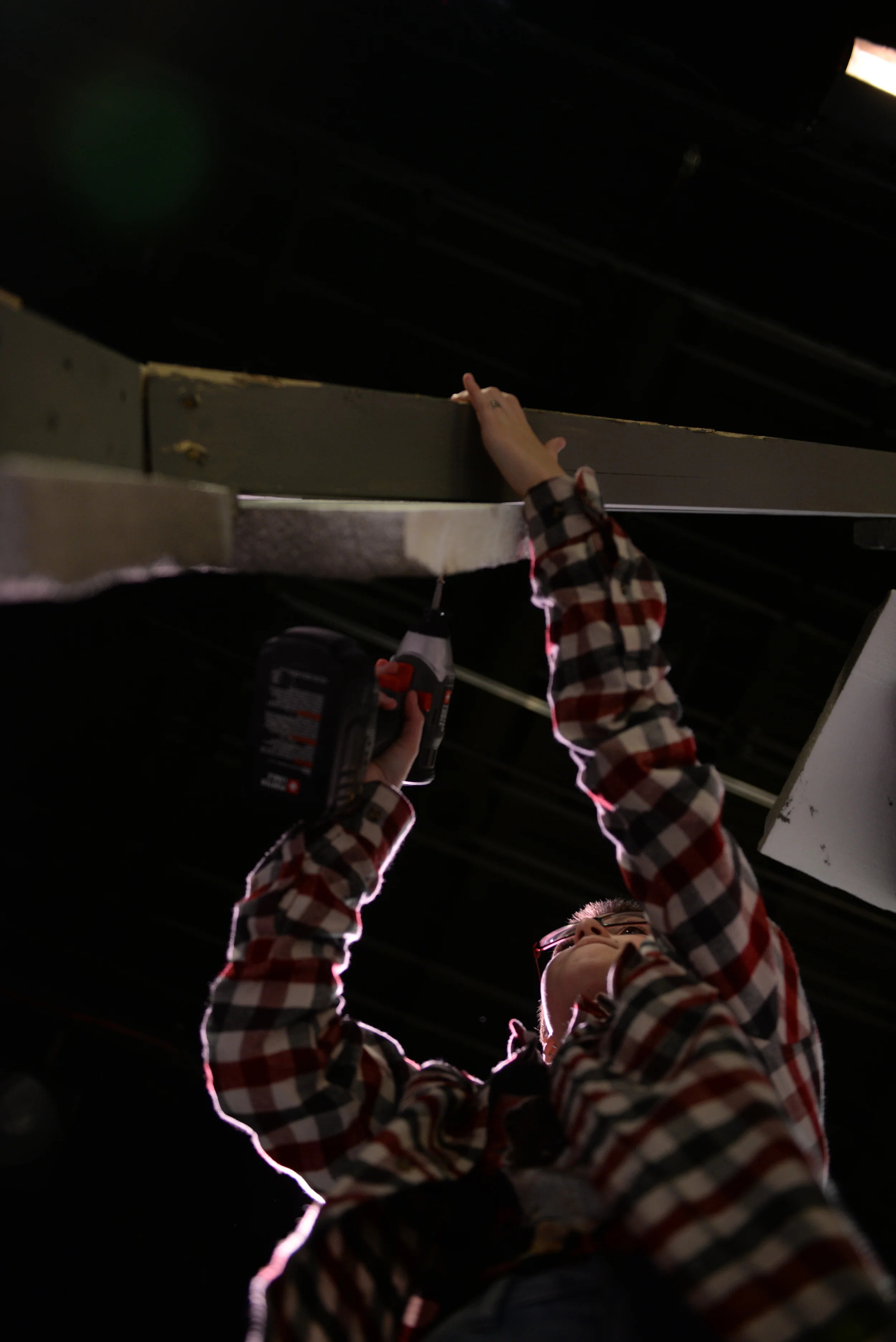  Battle High School sophomore Forest Miller drills into the stage set for its production of Cinderella during tech crew on Thursday, Nob. 6, 2014. As the backstage manager and a member of the set construction, Miller is required to stay after school 