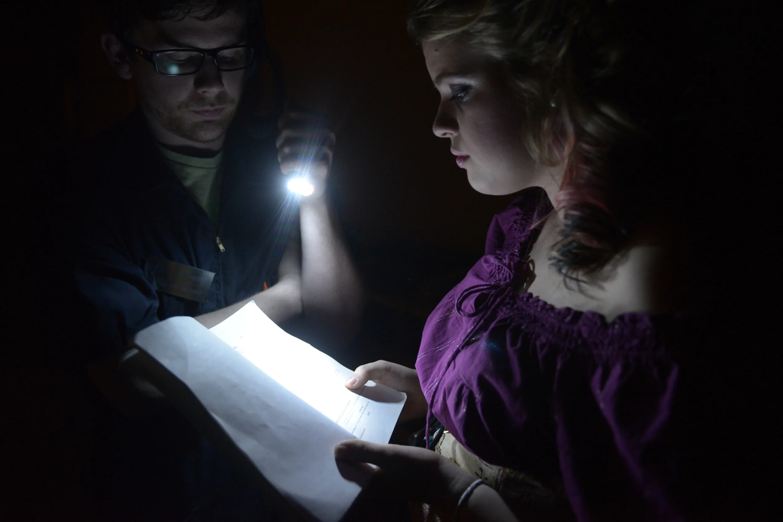  Performing Arts Center Theater Technical Specialist, Caleb White holds a light above Haley Mullen's script as she prepares to read her opening lines in the prologue during dress rehearsal on Tuesday, Nov. 11, 2014. Mullen is playing the role of Fair