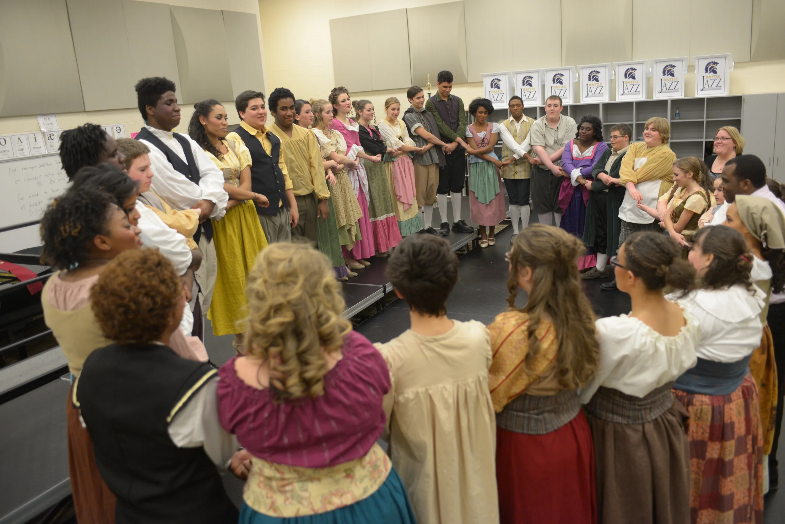  The on-stage cast of Battle's musical production, 'Cinderella,' listen to words of encouragement from director Jazz Rucker before taking the stage on opening night, Friday, Nov. 14, 2014. 