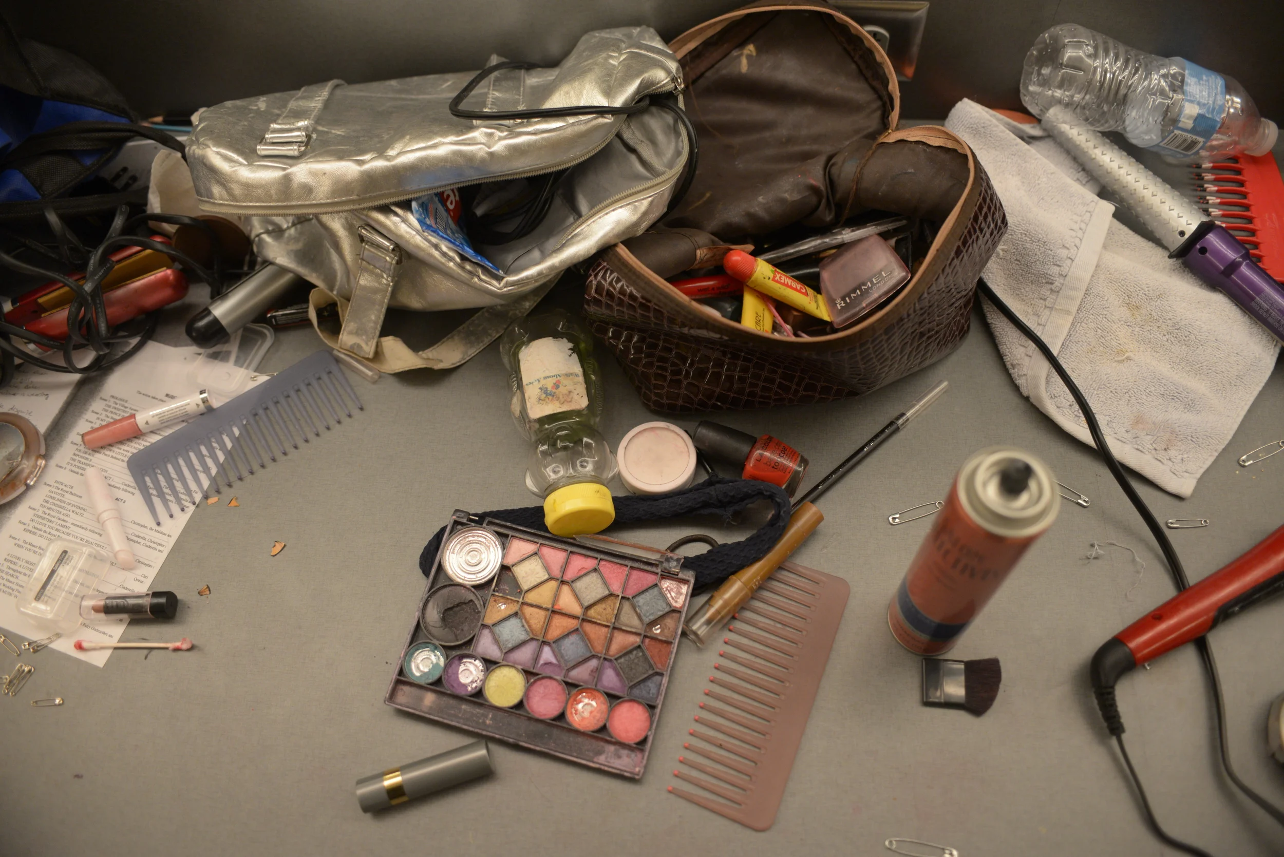  Colorful powdered make-up, sewing tools, and hair products lie scattered across the tables in the back stage dressing room during showtime of Battle's musical production 'cinderella' on Saturday, Nov. 15, 2014. 