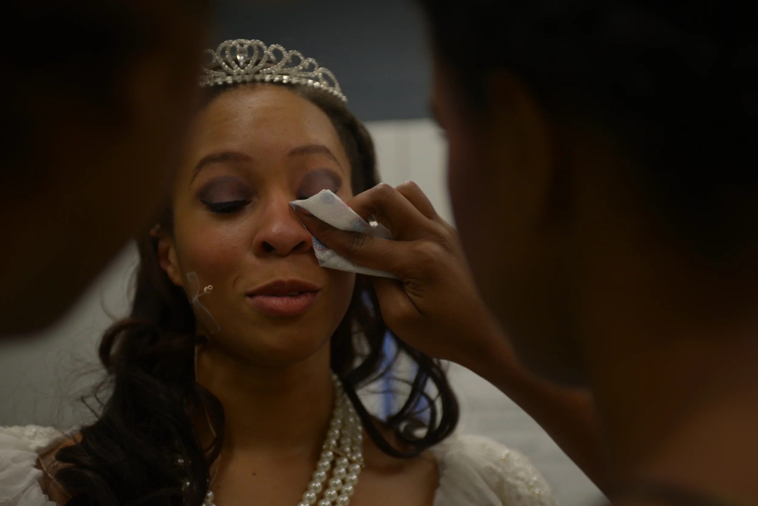  Bethani Thompson wipes Catera Combs teary eyes after reaching to the surprise cake with "Congratulations cast and crew!" written on it following Battle's musical production of 'Cinderella' on Saturday, Nov. 15, 2014. 