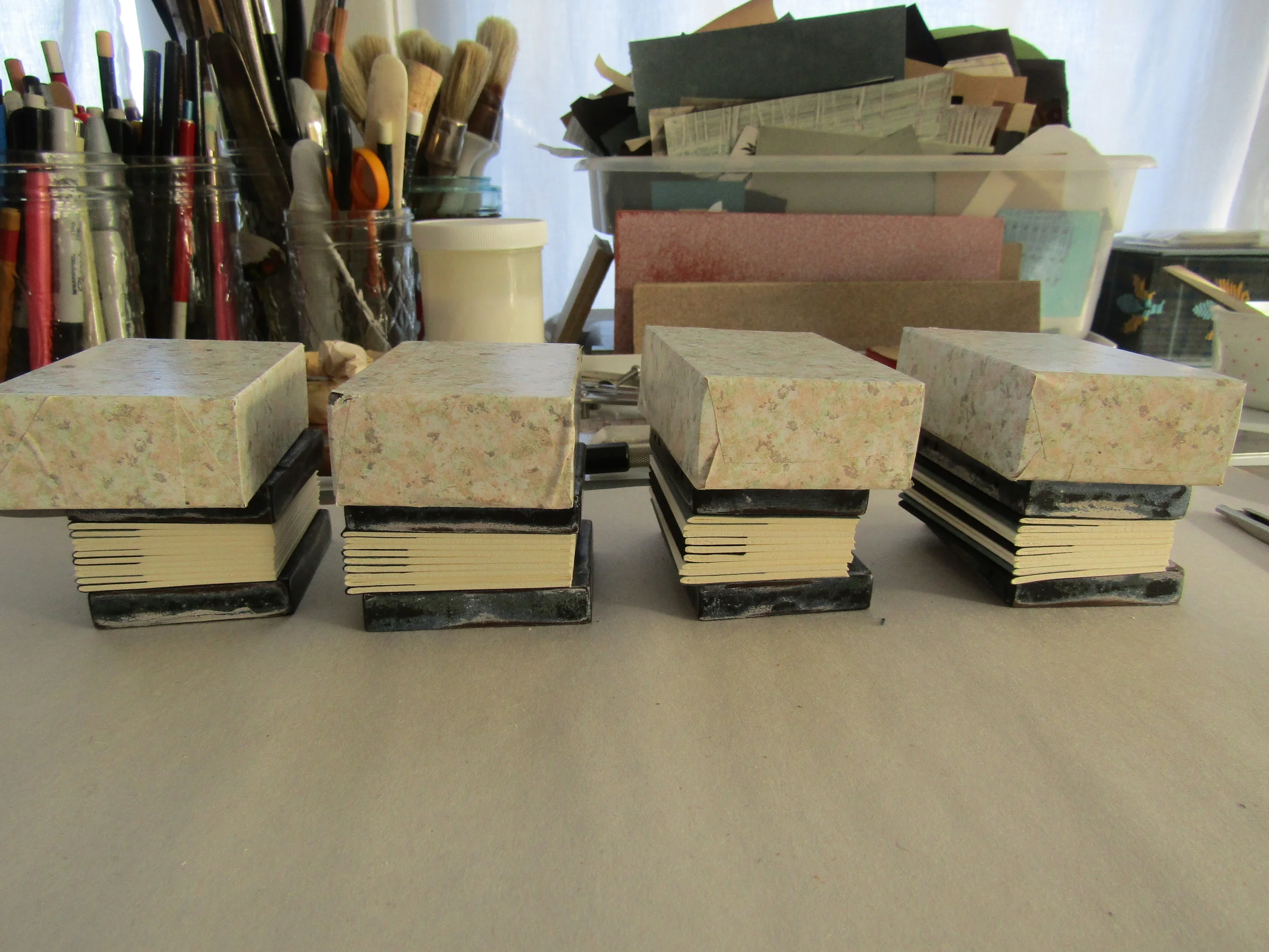 The text blocks are assembled and the sewing stations have been added using an awl - the books are now ready for sewing!