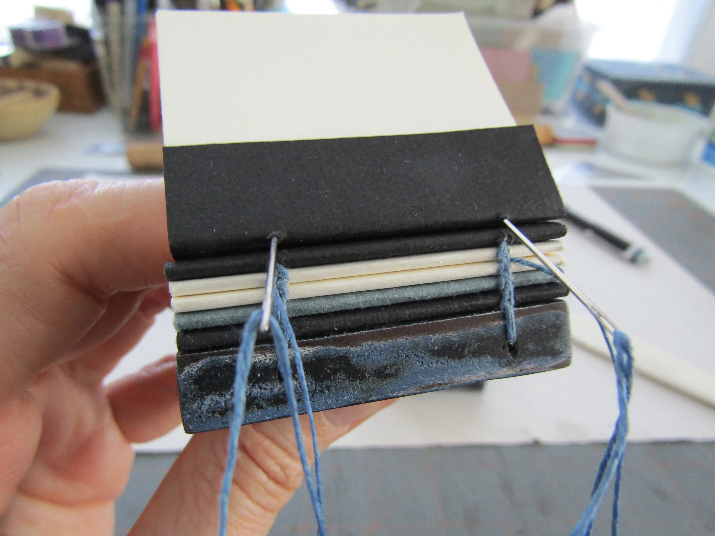 Sewing using two needles and waxed linen thread.
