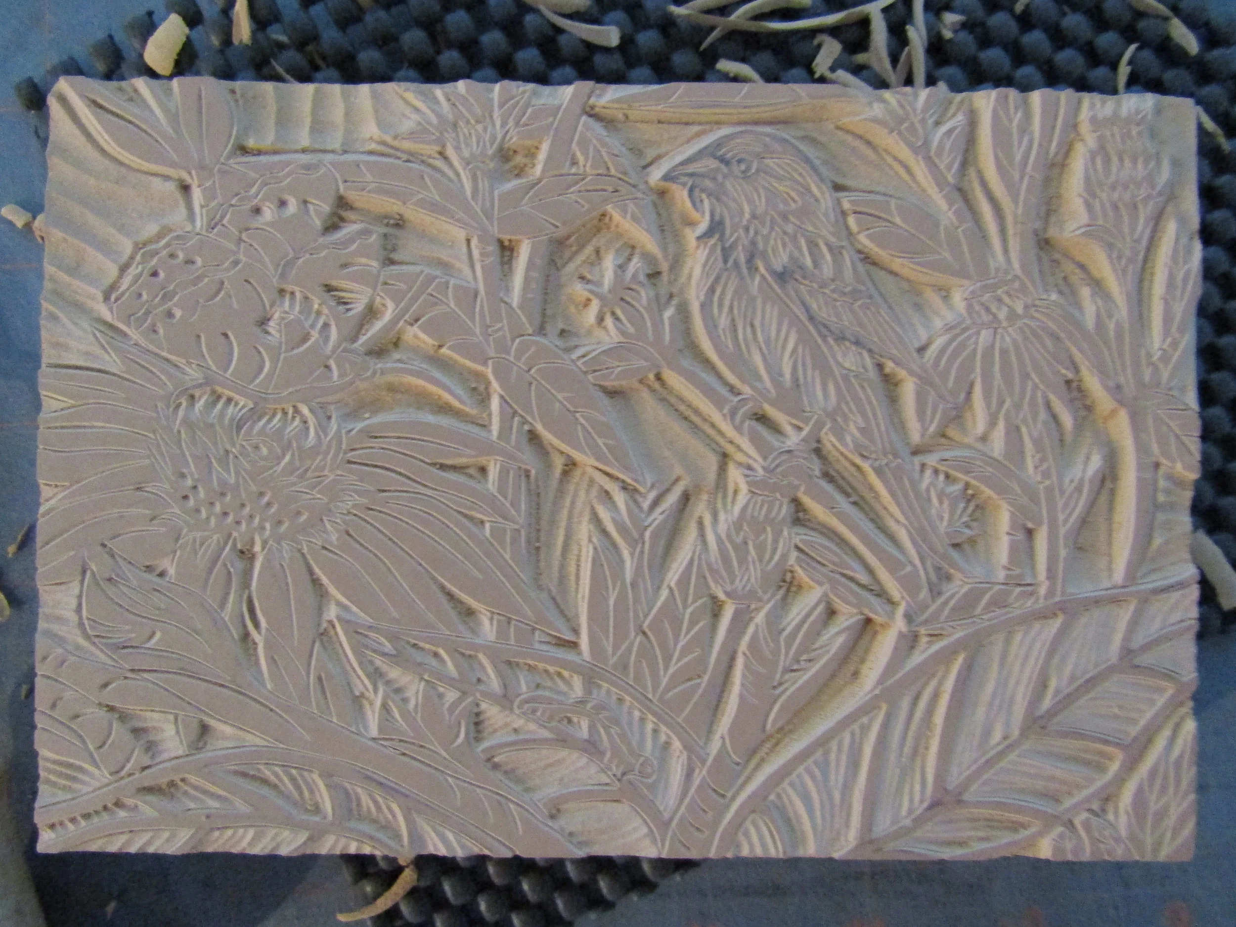 Carving the linoleum block for the relief print.