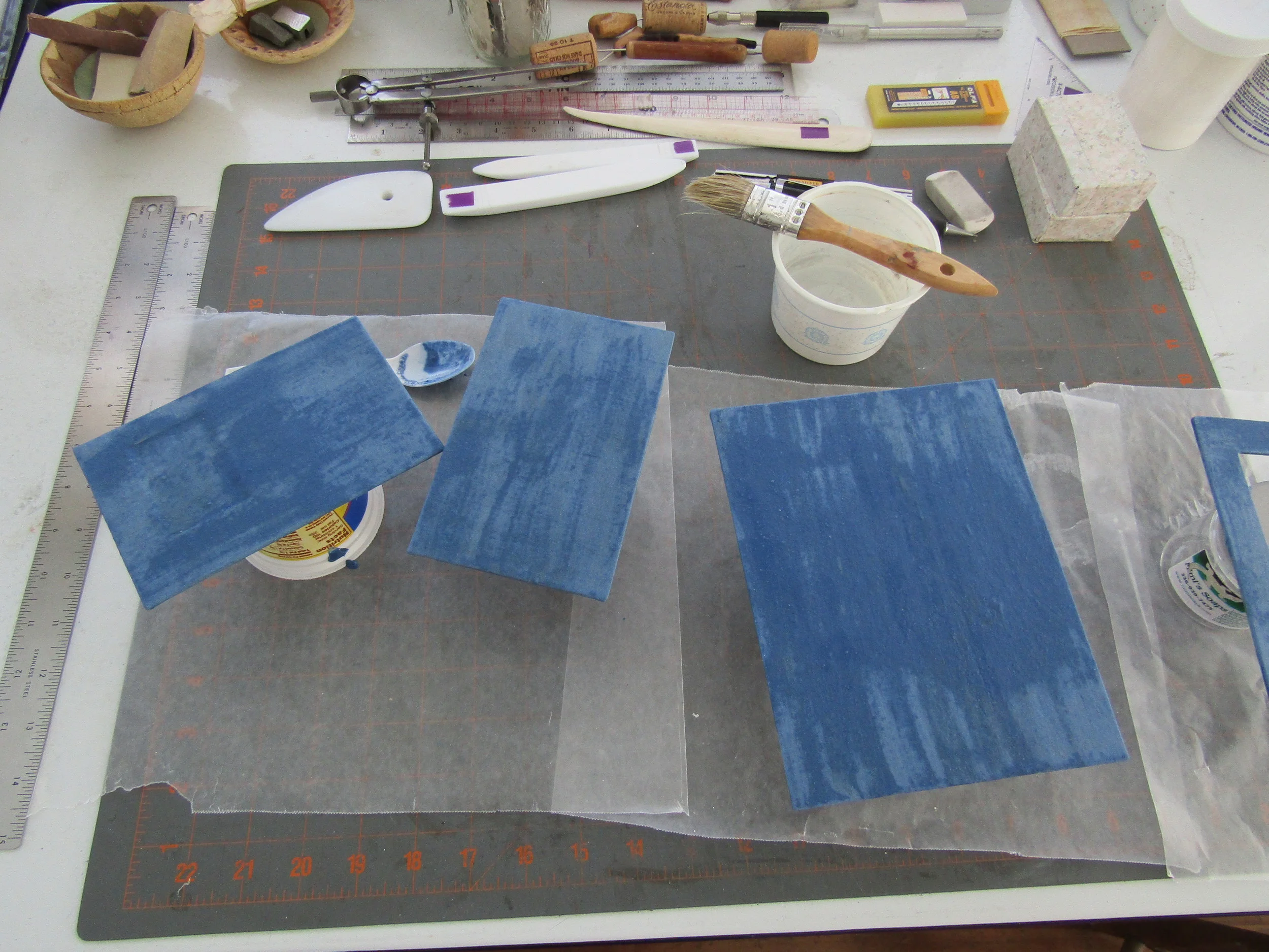 Painting the papyrus covered davey board with layers of milk paint.