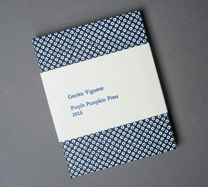 Cover with letterpress printed wrap.