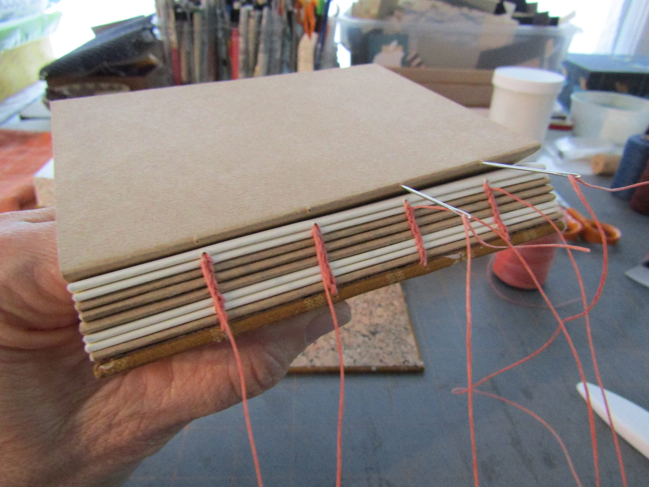 Sewing - adding the last section! I love how the stitching looks on the book's spine!