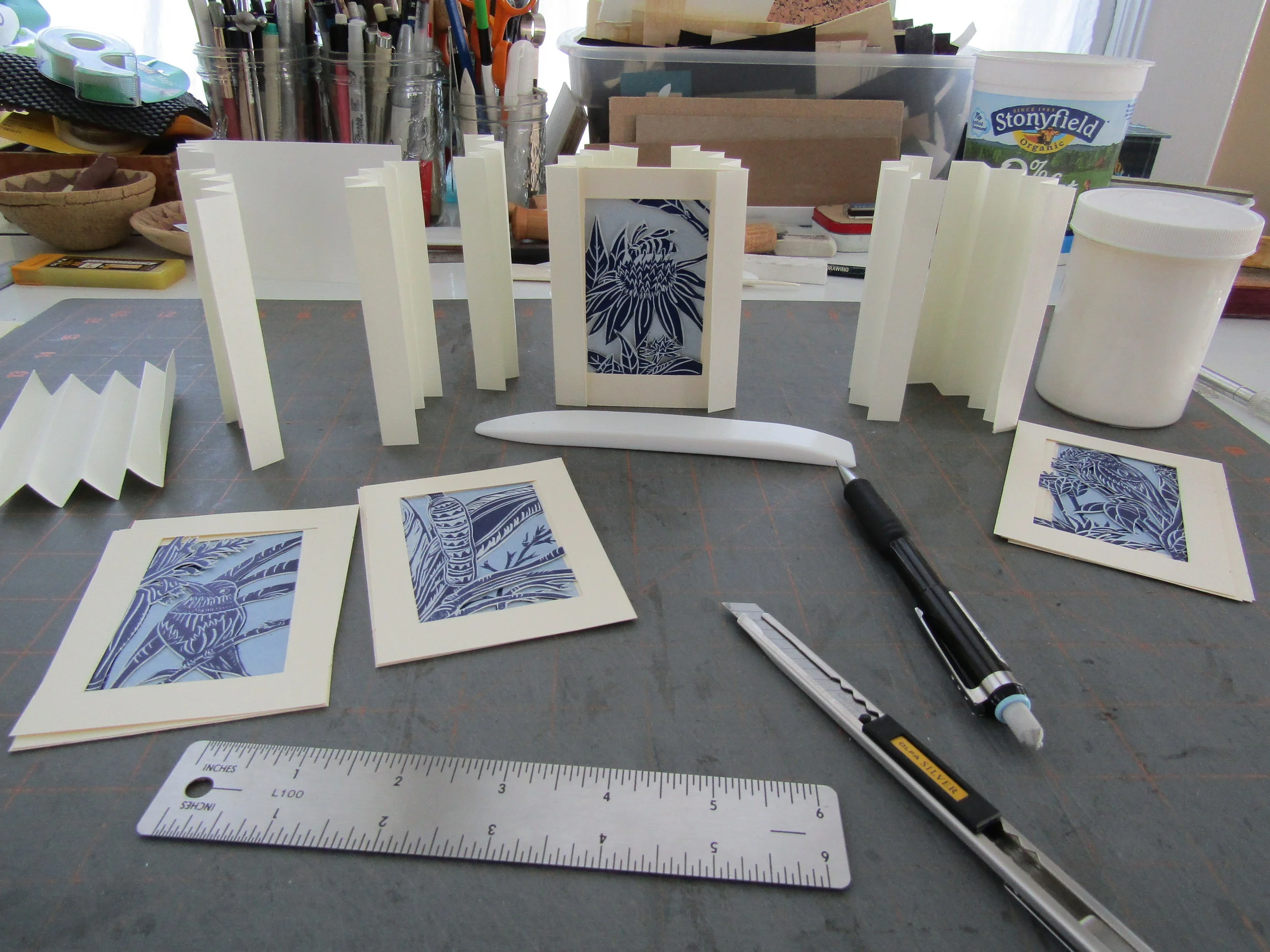 After cutting separate pages for each book I experimented with various papers for the sides of the books. Accordion folded pages are used for this. Bugra paper worked the best so I used it. I was then ready to glue and assemble the first book; which served as a model.