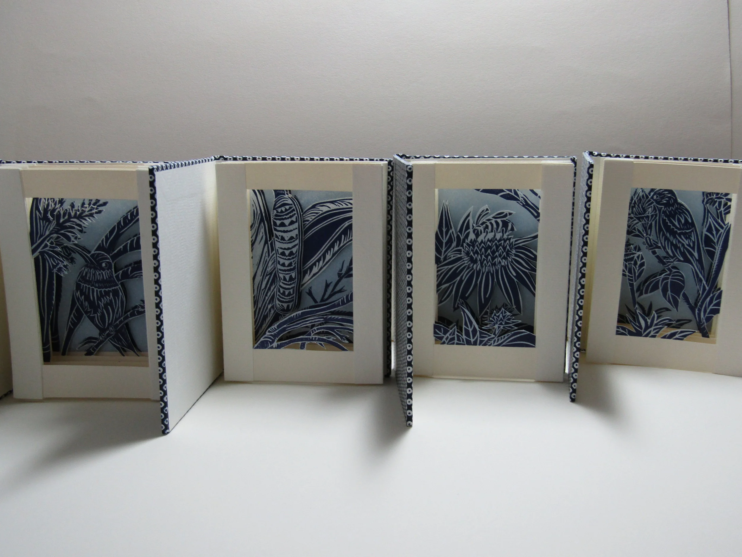 I have completed a book using each image. I then set a bit of type in 12pt. Garamond for the colophon and 'belly' wrap for the books.
