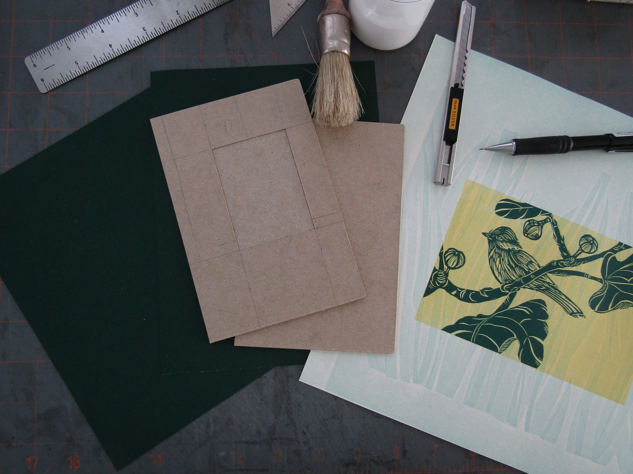 Here are the cover boards with a recessed area on the front cover. I used a beautiful green book cloth. I cut a small portion of this print to use on the cover.