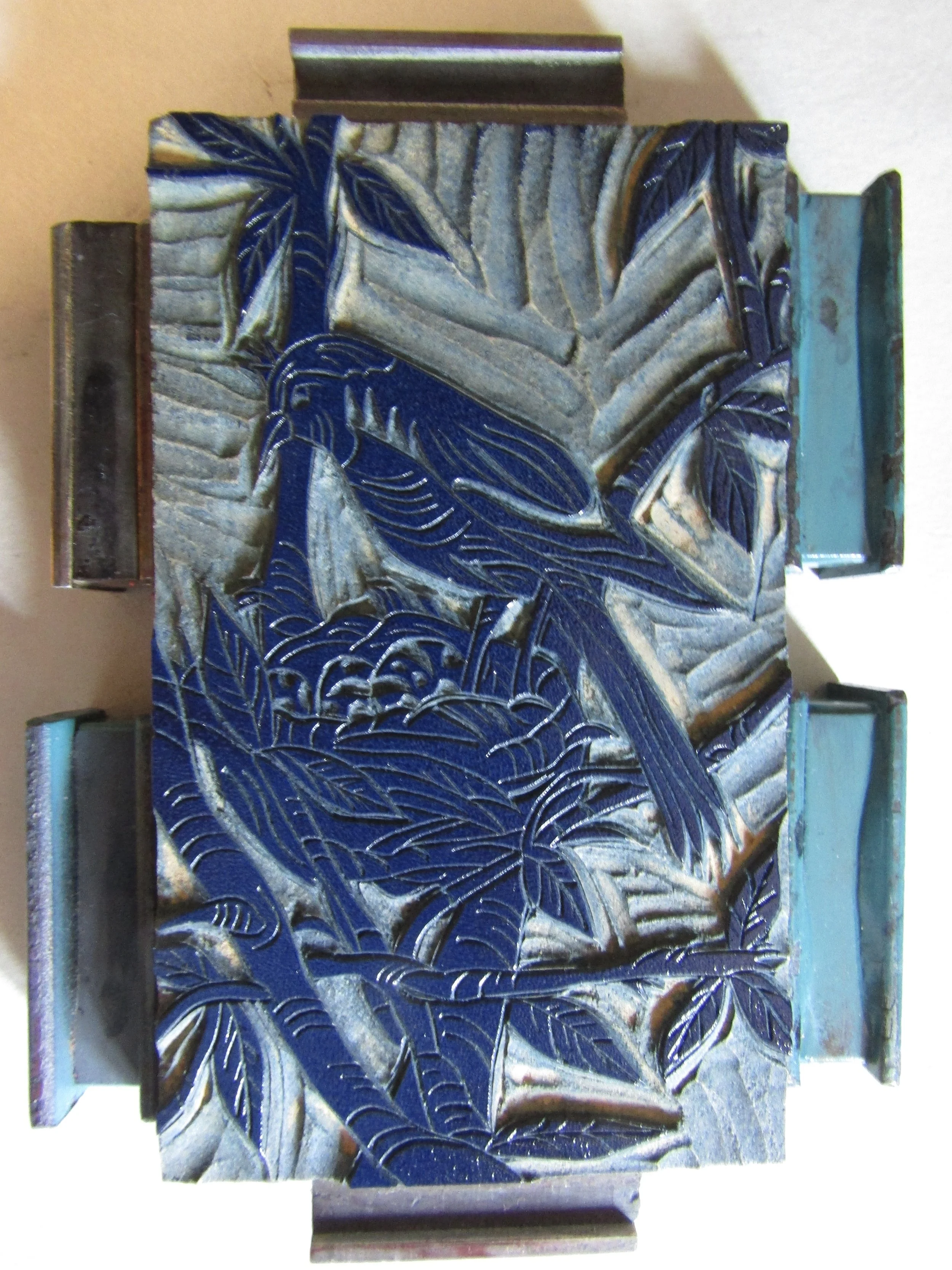 I have covered the bed of the press with newsprint as a way to keep the towels clean while printing. I then set the blocks up using magnets - very simple. I ink the block using a hand brayer and am now ready to print.