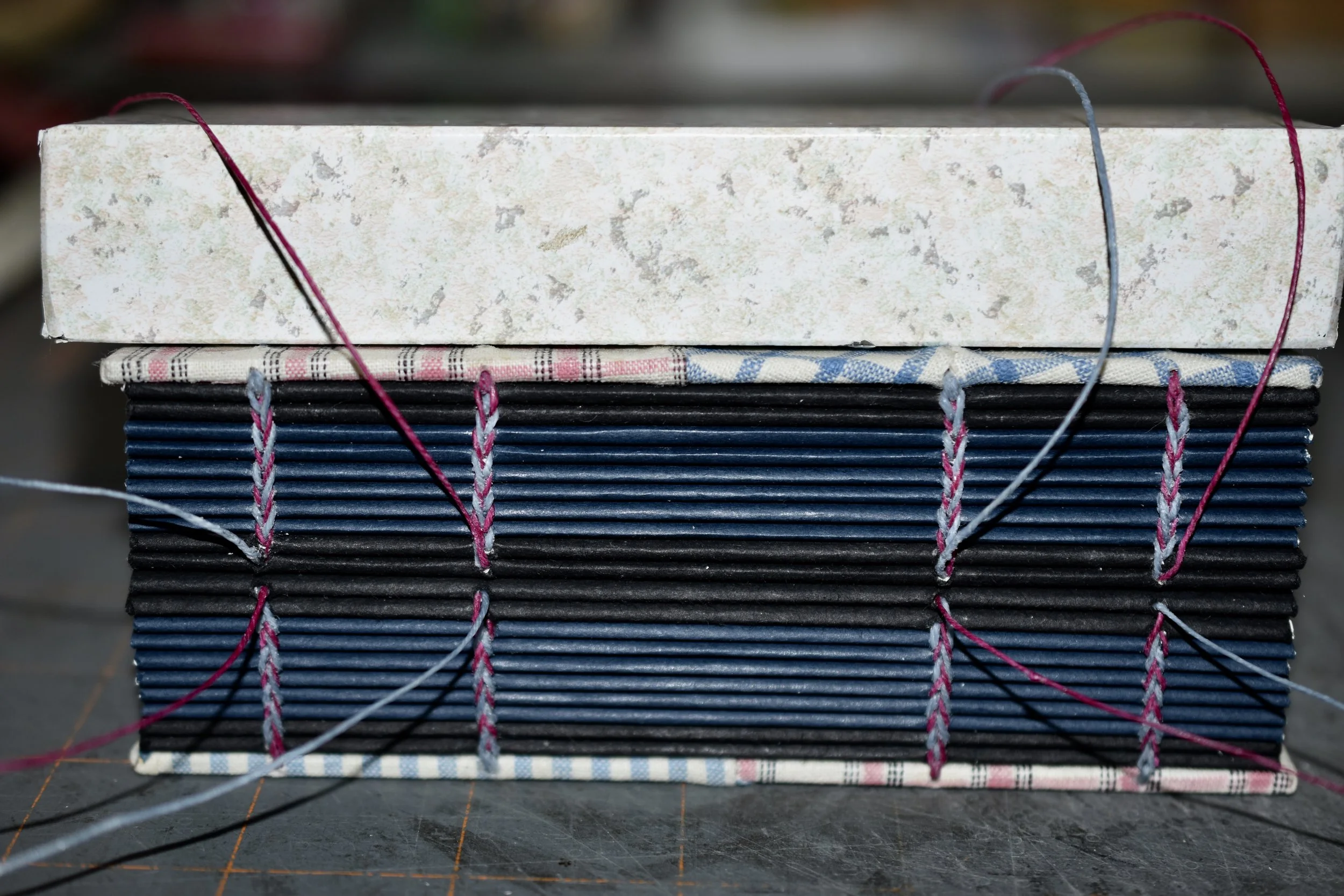 Each half has been sewn using a chain formed by locking the loop stitch. The two halves will be joined by alternately linking the top and bottom threads (similar to braiding).