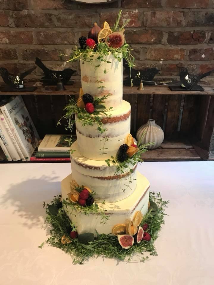 Semi naked cake with fresh herbs and fruits hexagon base tier.jpg