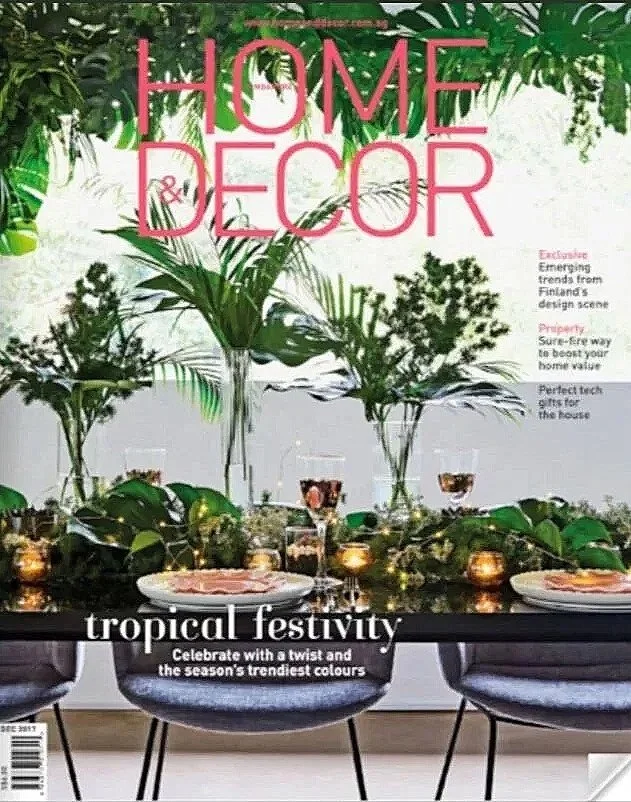 Home Decor magazine cover featuring a tropical theme with lush greenery, a stylish dining table, and vibrant colors, highlighting trends and ideas for festive decorations.