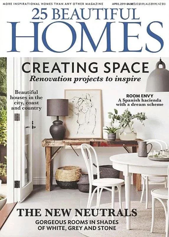 Cover of 25 Beautiful Homes magazine, April 2019 edition, featuring interior design with neutral tones of white, grey, and stone, highlighting renovation projects. Headline mentions 'Creating Space' and 'The New Neutrals.' Image shows a stylish room with wooden table, plants, modern chairs, and a lamp.