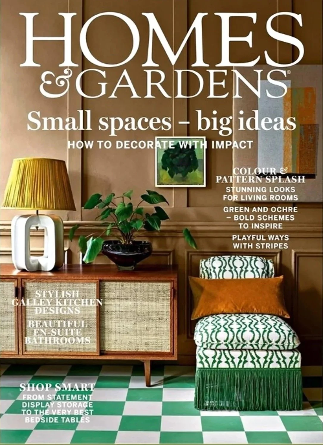 Cover of Homes & Gardens magazine featuring interior design with green and white checkered floor, a patterned chair with fringe, a wooden sideboard, and decorative items.
