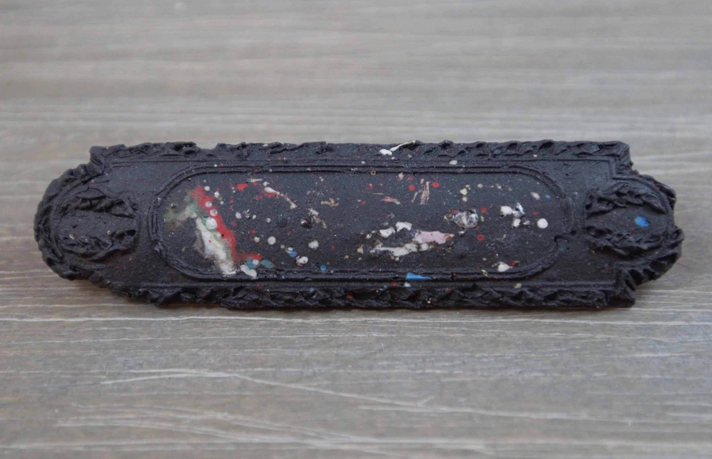 black porcelain slip decorated magnet