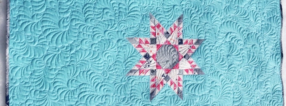 The feathered star block is shown here at 16" square, I surrounded it with solid fabric to make a one-block baby quilt. Psst! I made a video showing how I draw/quilt those fancy feathers in the background here .