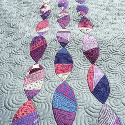 Close-up of pieced appliqués, tutorial for background quilting found here: overlapping spirals