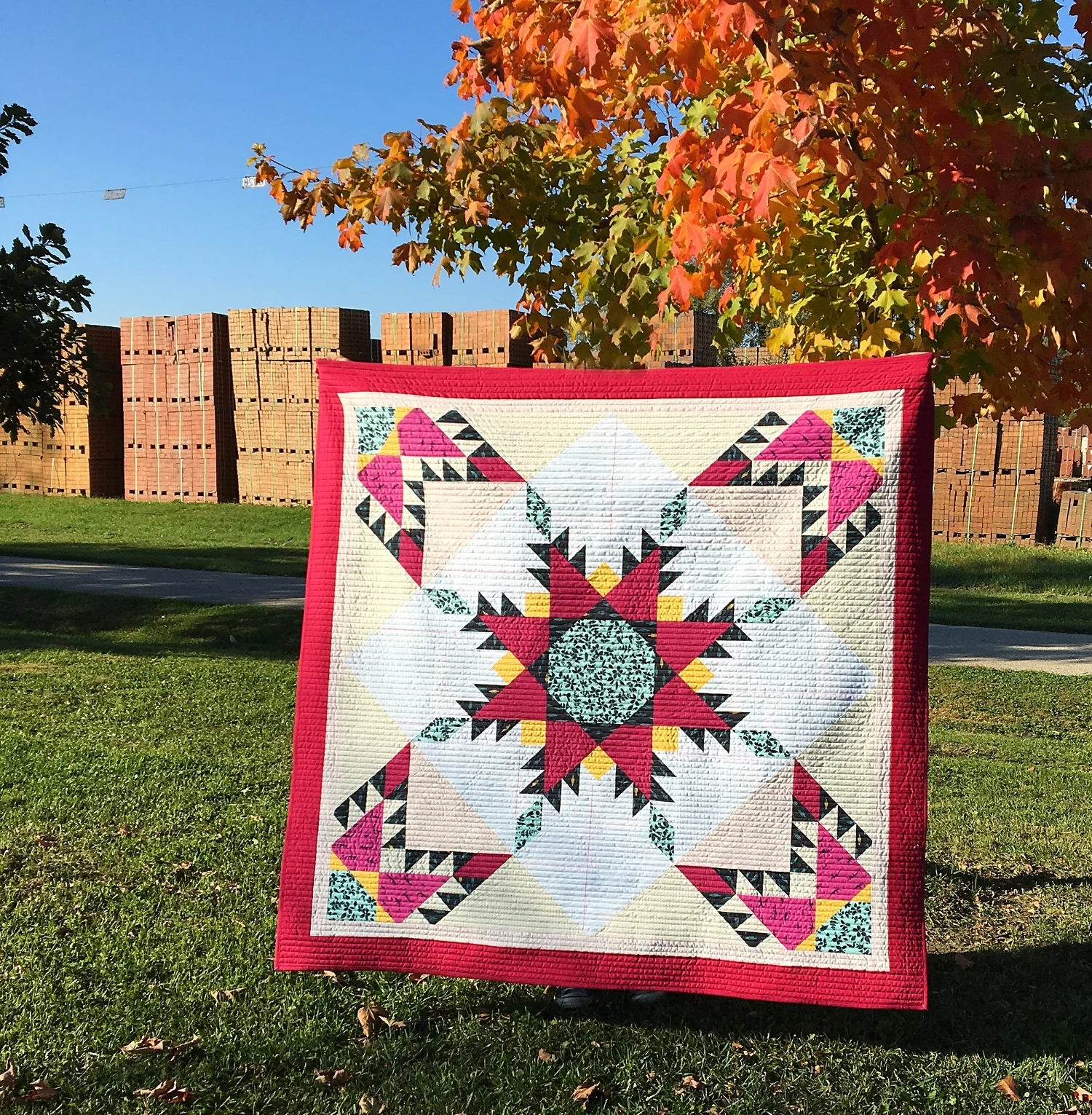 This is my Fierce Feathered Star pattern shown in the 36 inch version (center) with another 36 inch star cut apart and added to the corners. Including the borders, this finished at 60" x 60".