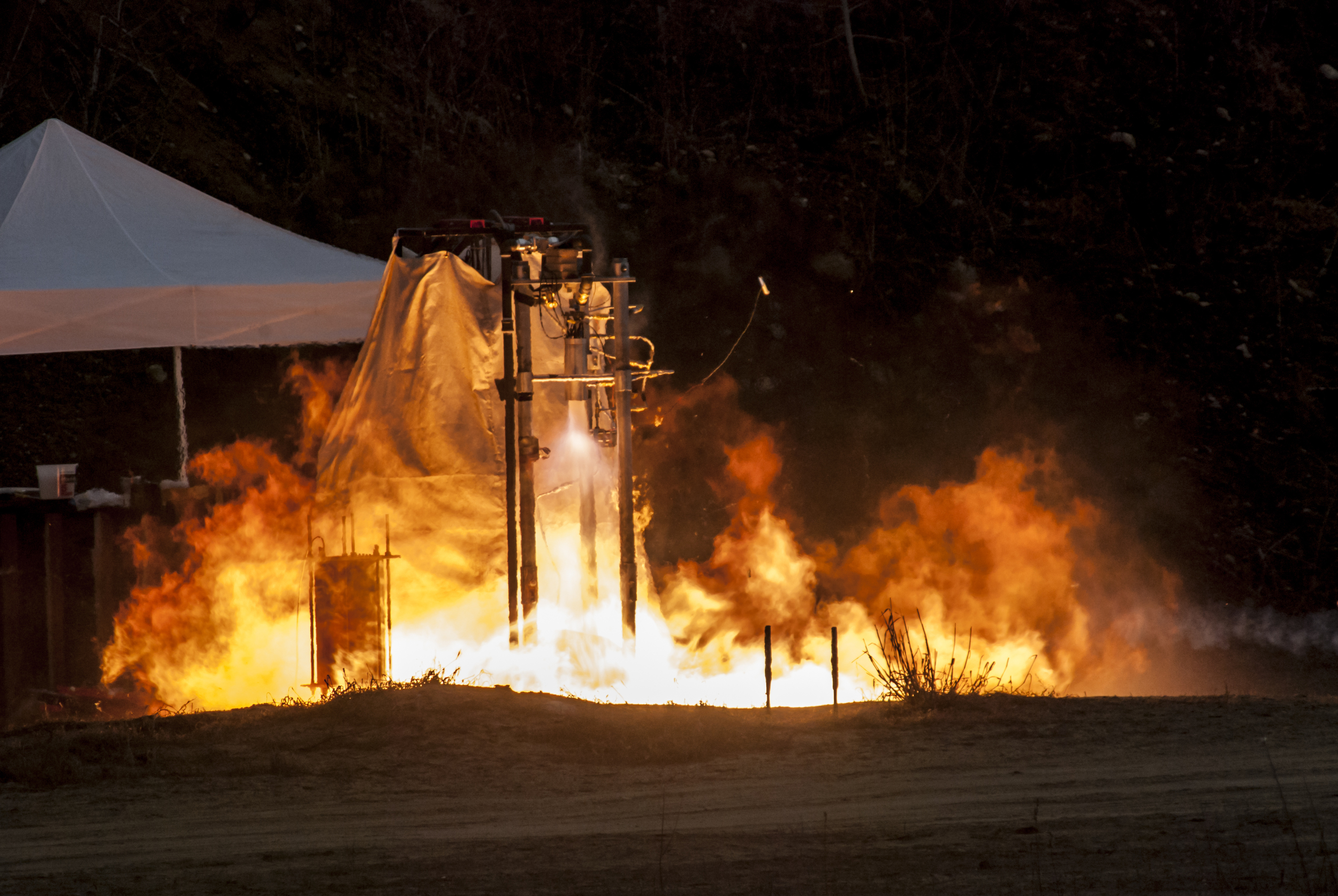 "Flamethrower" behavior from combustion occurring outside chamber