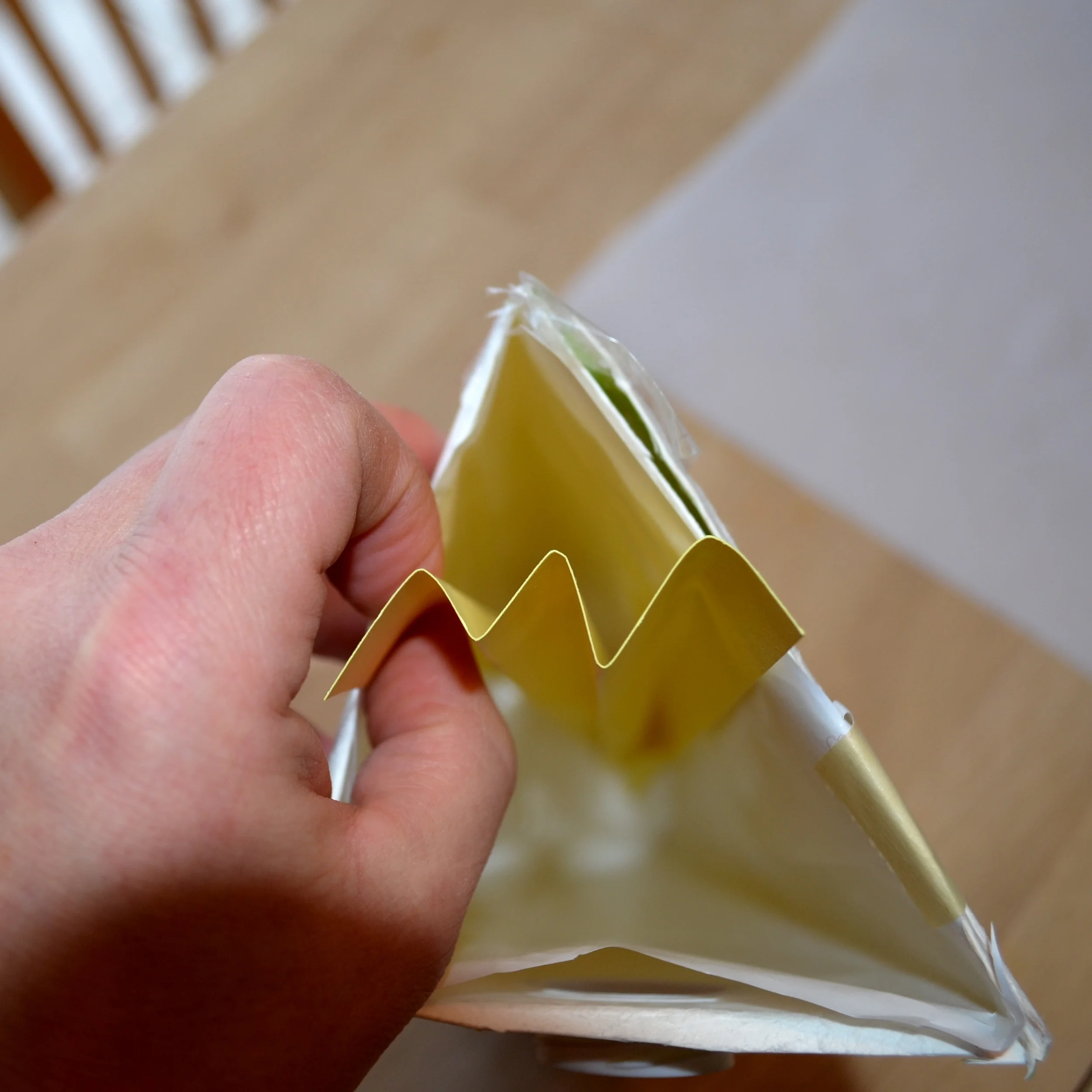 The peaked card stock is fit into the mold in a very particular fashion.