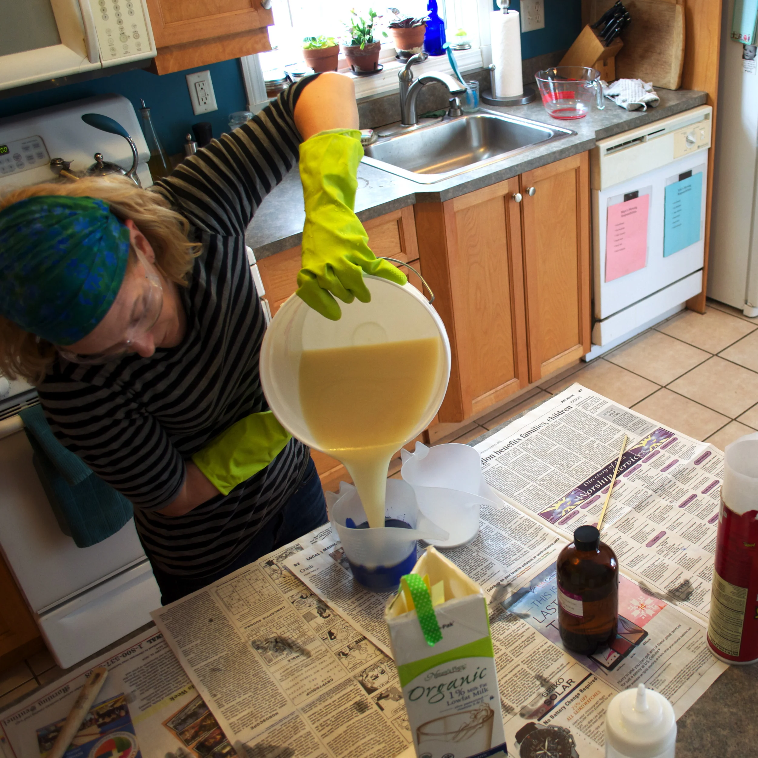 Now, I'll just pour the soap into the containers with the colorants.