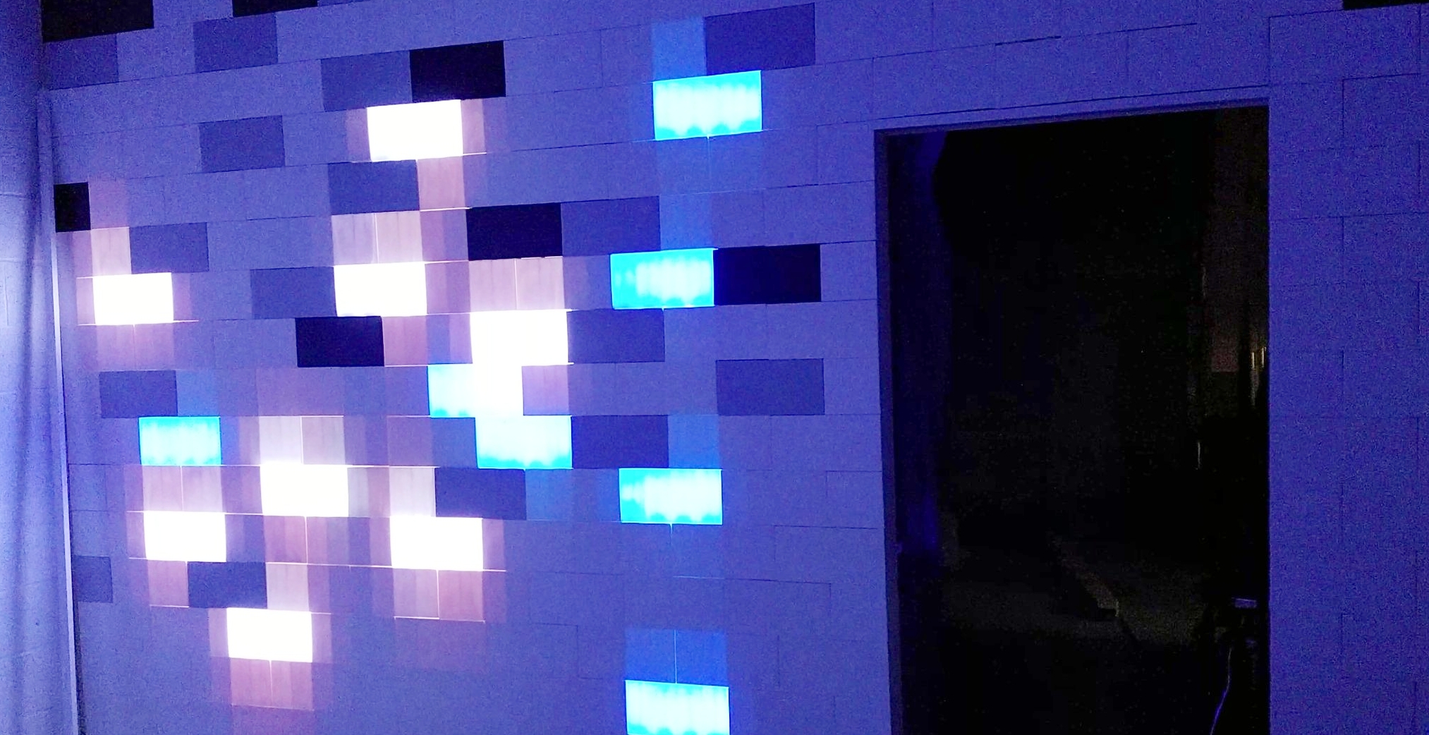 Two control modules can generate 256 different colors for the 8 blocks each illuminates. Those modules are wi-fi controllable from a mobile device. If I get bored with this pattern, I can always take the wall apart and rebuild something different. 