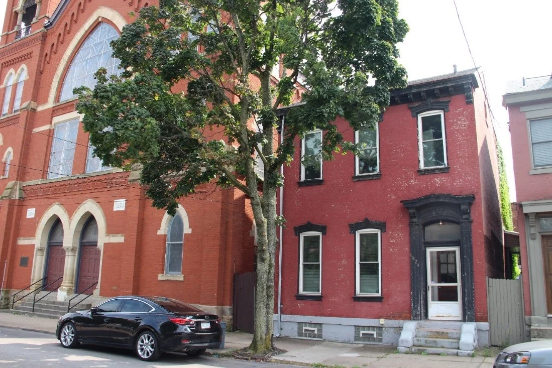 11 View southeast, showing church and a ca. 1880 rowhouse at 1924 Sarah Street that once served as the manse.jpg