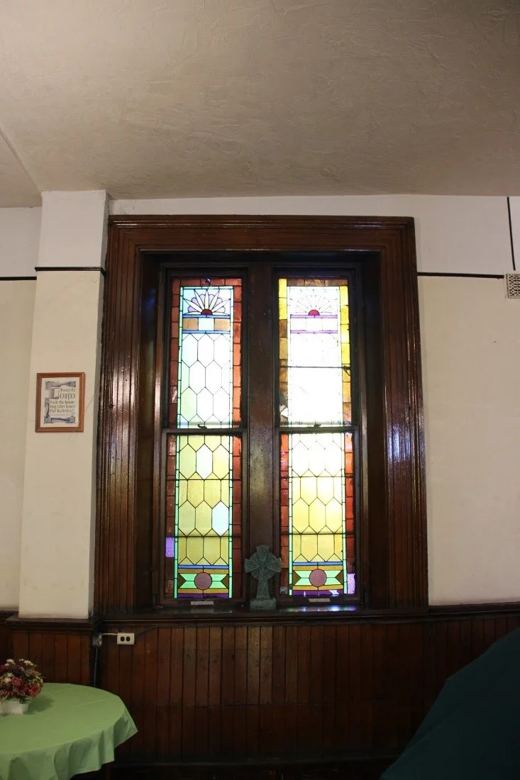 31 Detail of a typical stained glass window and wainscot in the 1st floor Sunday school room.jpg