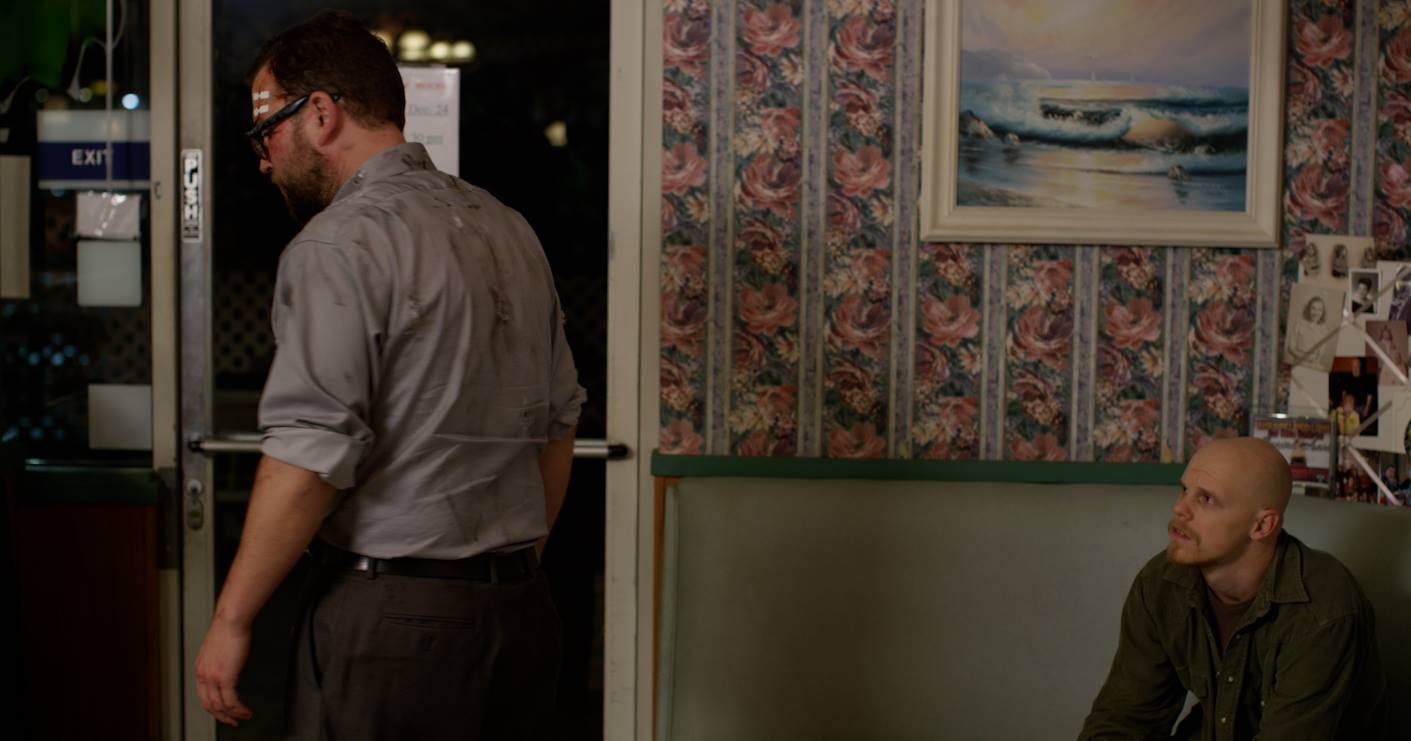 Raw still from "The Shift." Kevin (Greg Tharpe) at the door while Mark (Mark McPherson) looks on.