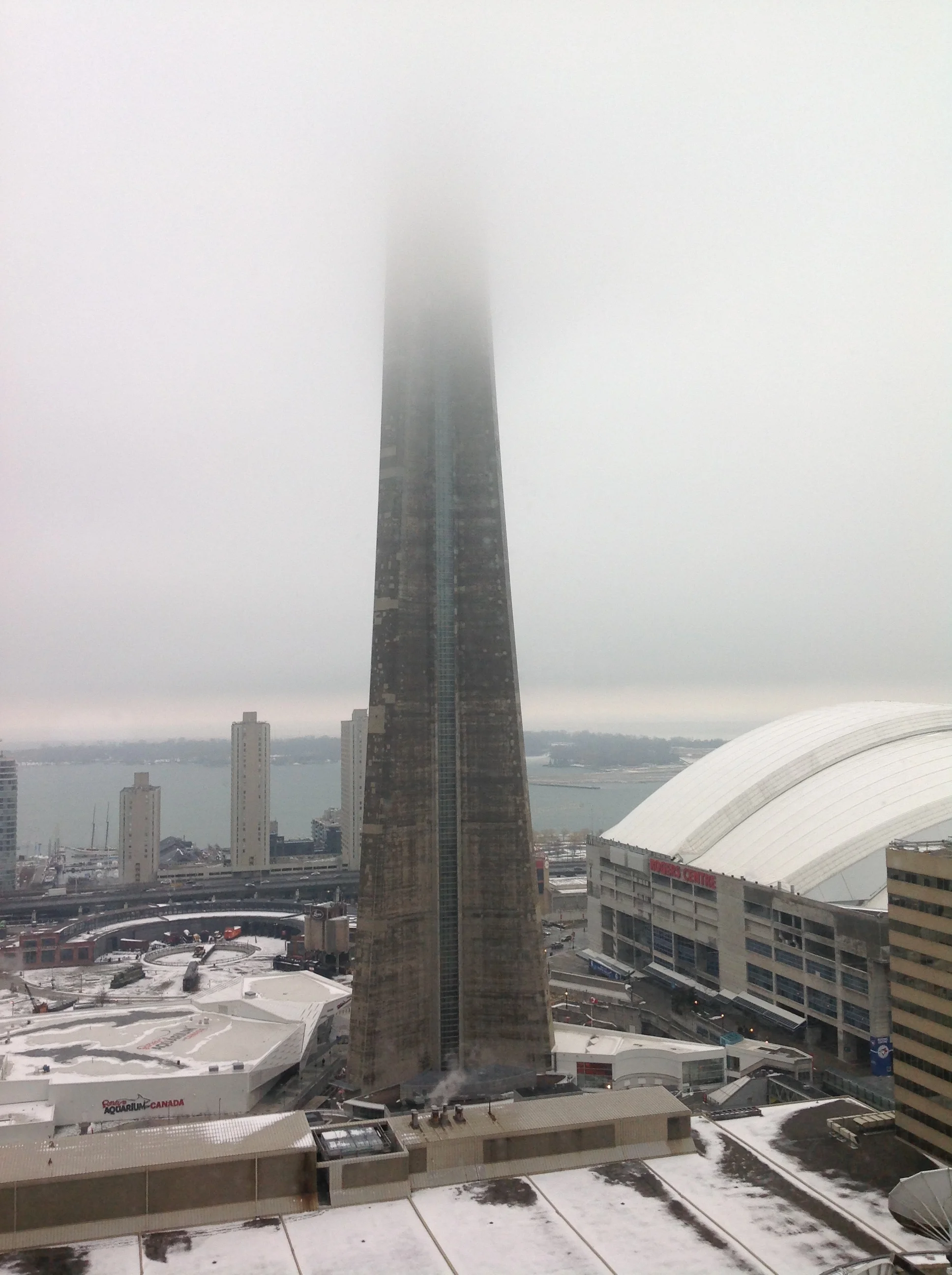 A view from my living room. CYTZ (Toronto Island a.k.a BIlly Bishop Airport) was reporting the ceiling at 700 feet AGL. Makes sense.