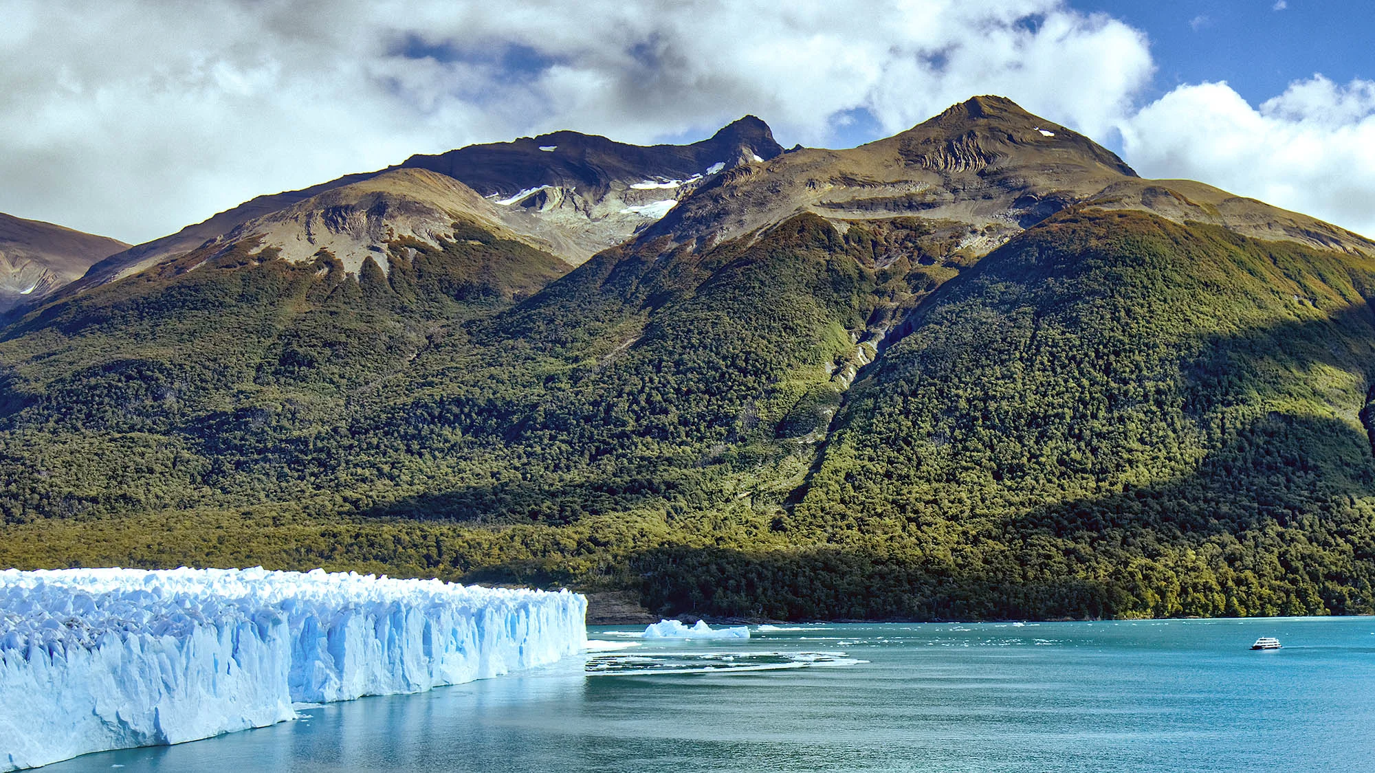 Perito Moreno Glacier dwarfs a tour boat